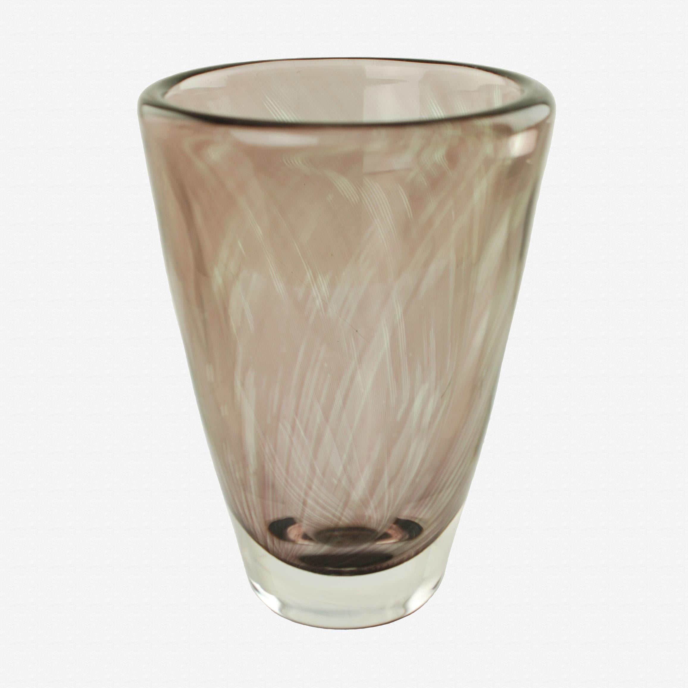 This heavy Orrefors Graal glass vase was designed by highly regarded Swedish designer Edvin Öhrström (1906–1994). The piece has a classic flared cylindrical shape and features a thick layer of clear glass over a smoky amethyst color. The 5lb 8oz
