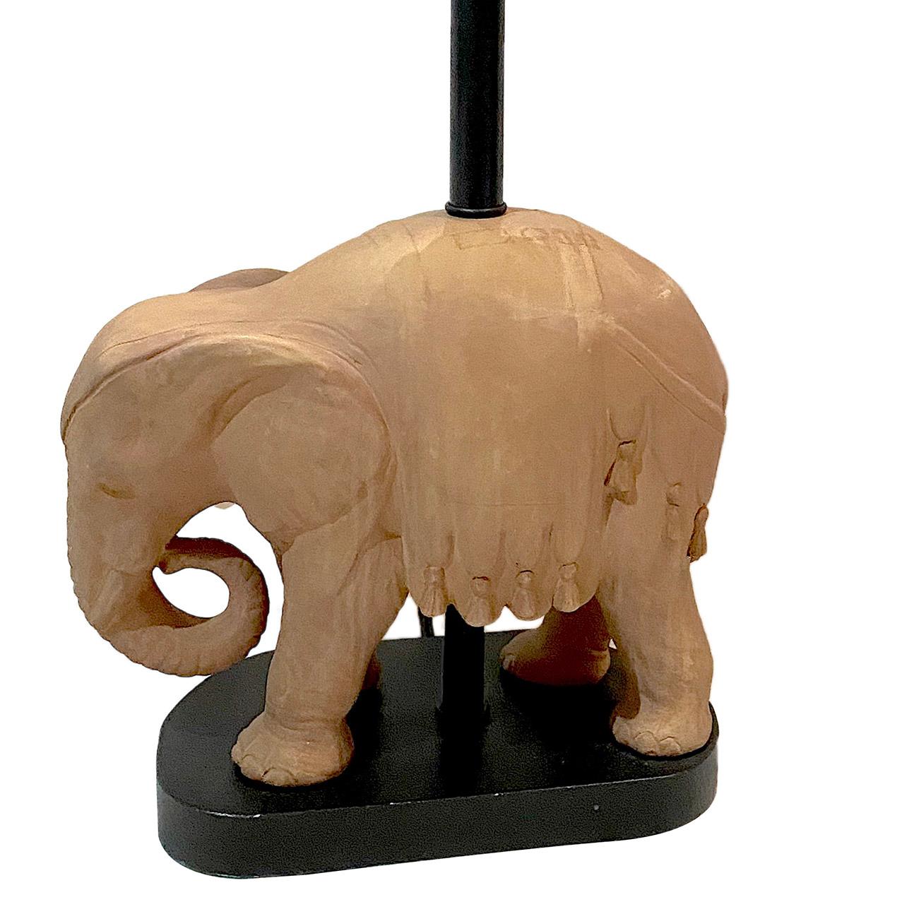 A circa 1950's French terracotta elephant table lamp with a wood base.

Measurements:
Height of body: 12