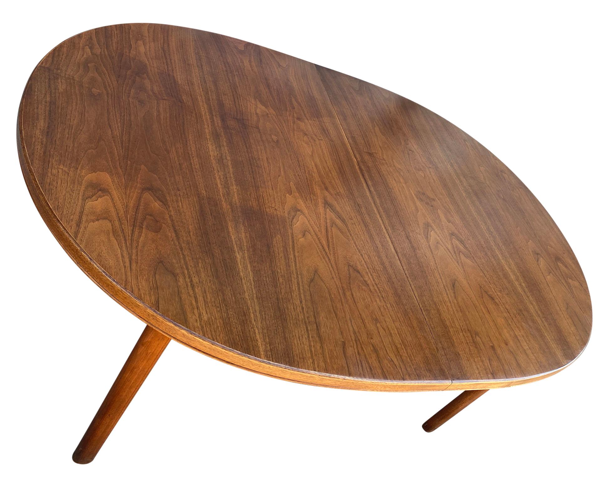 Midcentury solid teak Elliptical oval Danish Swedish dining table. This table is very high quality hand built in Sweden. Solid teak legs with 4 leg base. This table is in great vintage condition, the (0) leaves. Beautiful wood grain. Beautiful teak
