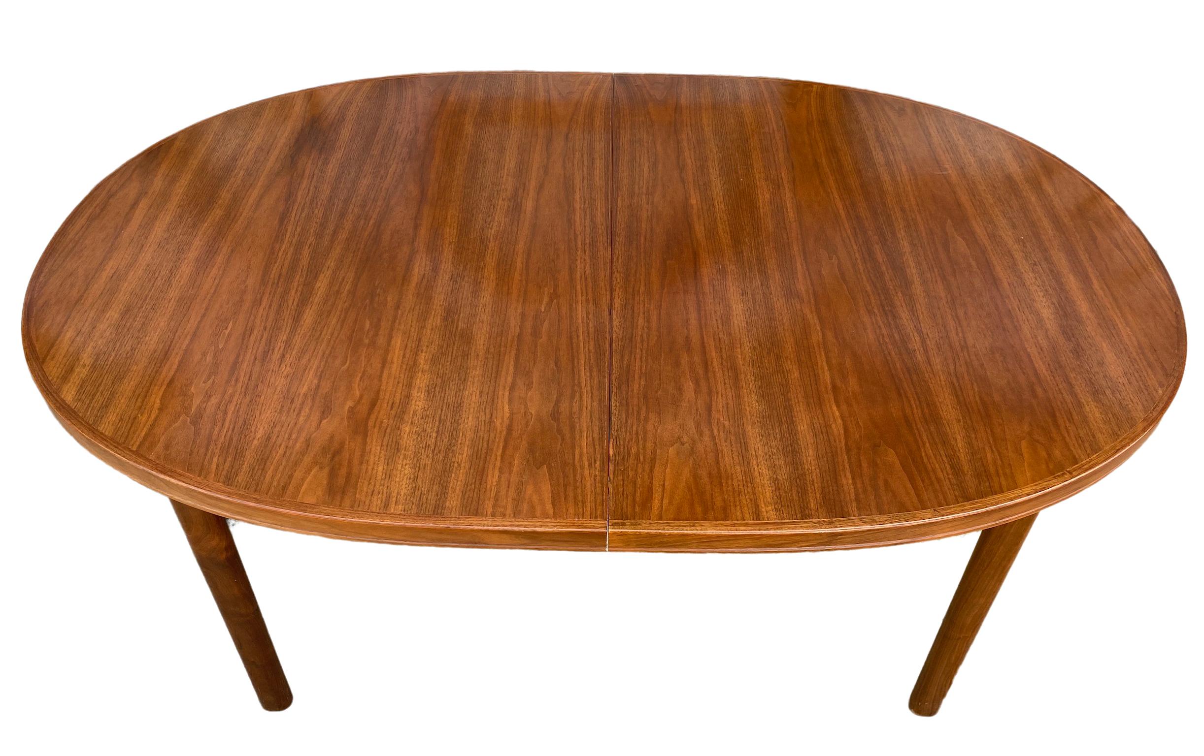 Midcentury solid teak Elliptical oval Danish Swedish extension dining table with (2) leaves. This table is very high quality hand built in Sweden. Solid teak legs with 4 leg base. This table is in great vintage condition, the (2) leaves match the