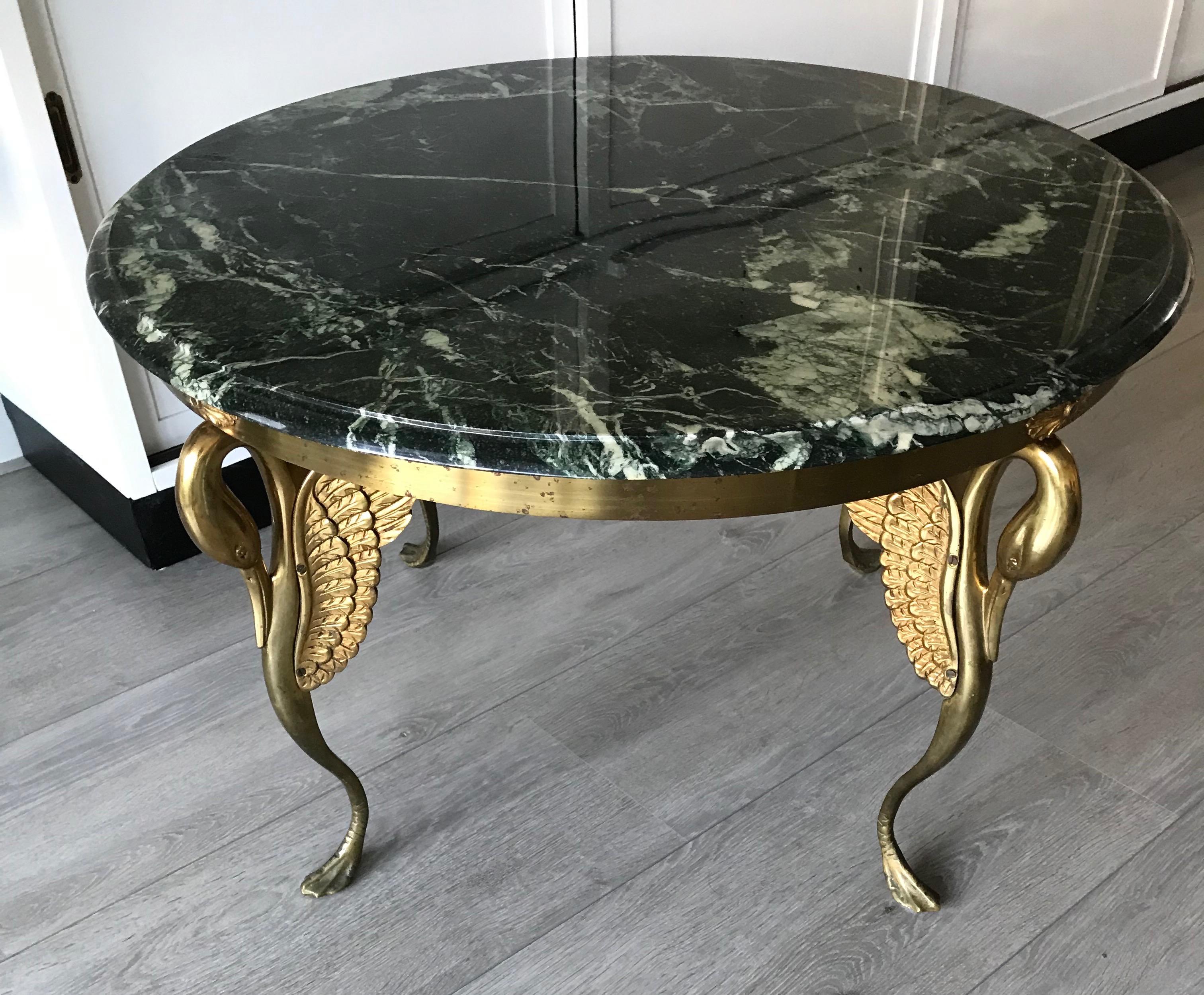Good size, practical and very decorative round coffee table.

This beautiful quality coffee or end table is highly decorative and it comes with impressive details. The best ofcourse are the four elegant and stylized, bronze swan legs. Their grace