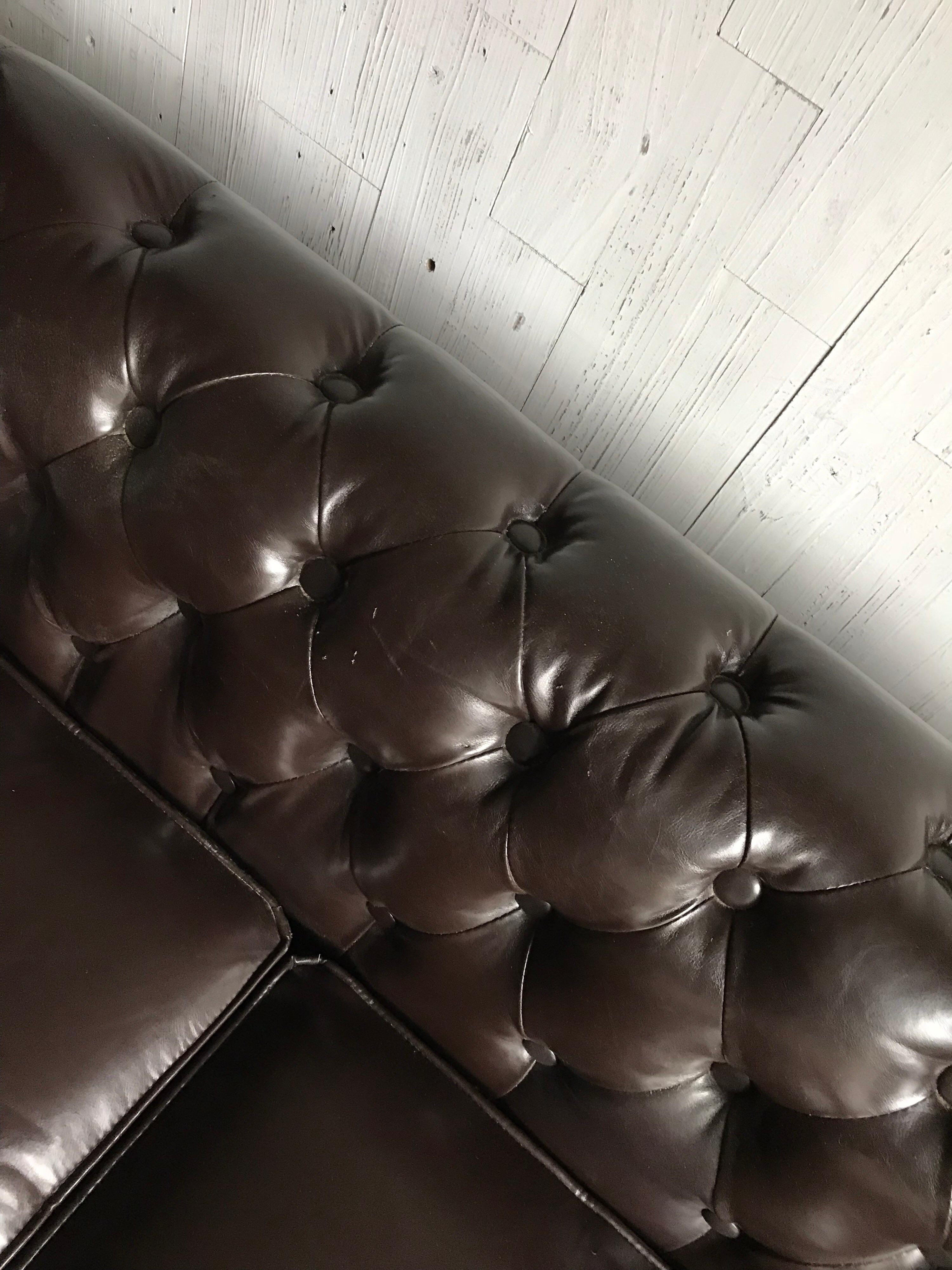 English mid-20th century emerald tufted Chesterfield sofa with a rich dark brown leather upholstery with three cushions.