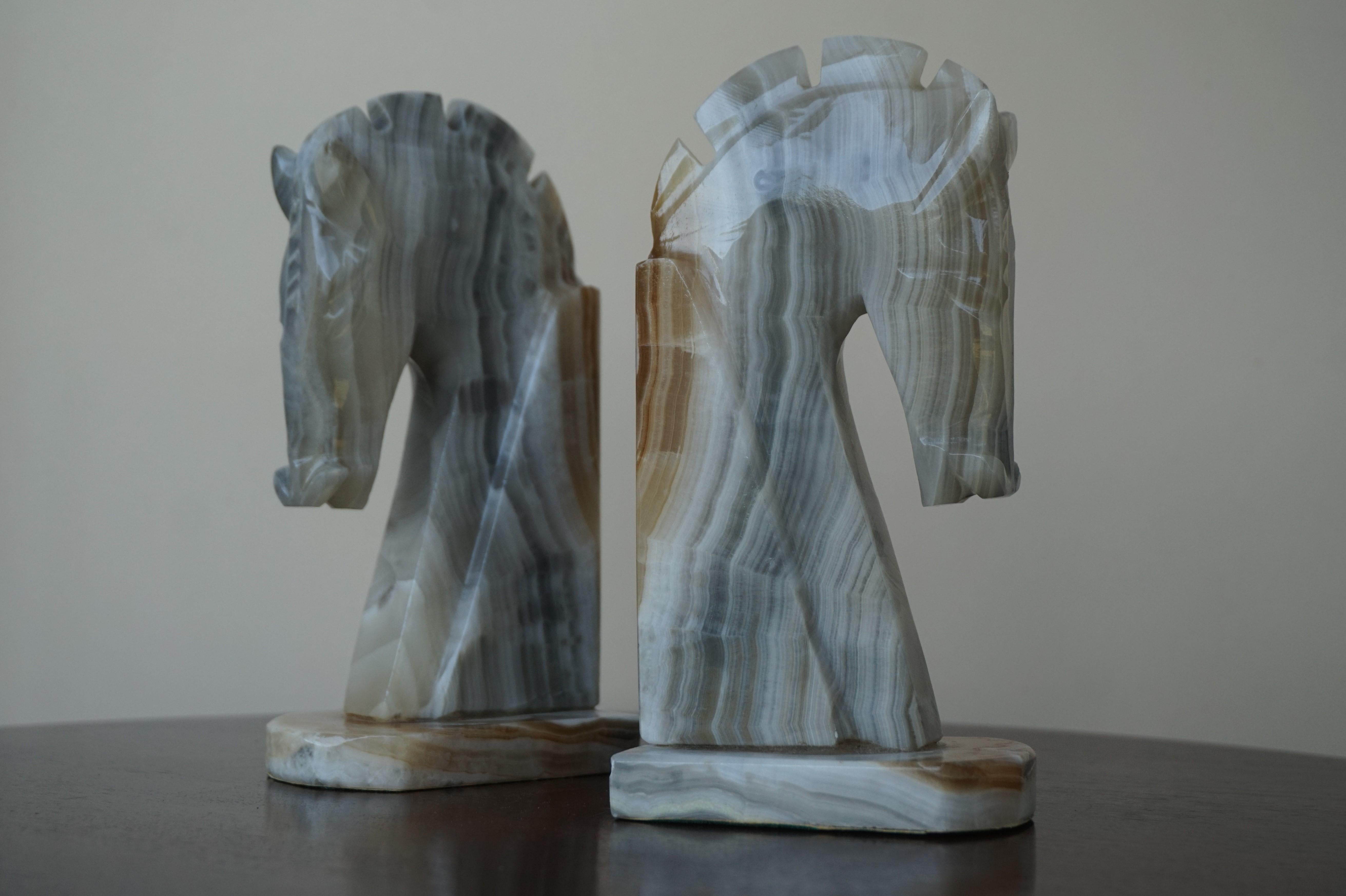 Beautiful, practical and decorative, mineral stone bookends.

The shape of these stunning, small size horse bookends resembles that of chess pieces and their geometrical design is very much Art Deco in style. But what makes this hand carved pair