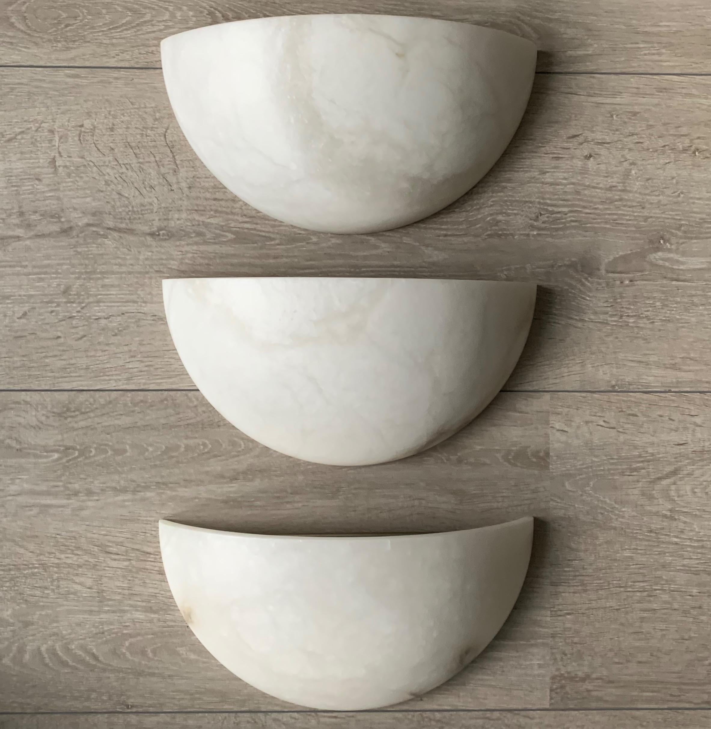 Wonderful looking and easy to mount set of three alabaster wall sconces.

If you are looking for a stylish and timeless way to bring light into your entry hall, bathroom, kitchen or bedroom or if you are looking for the perfect wall lights over your
