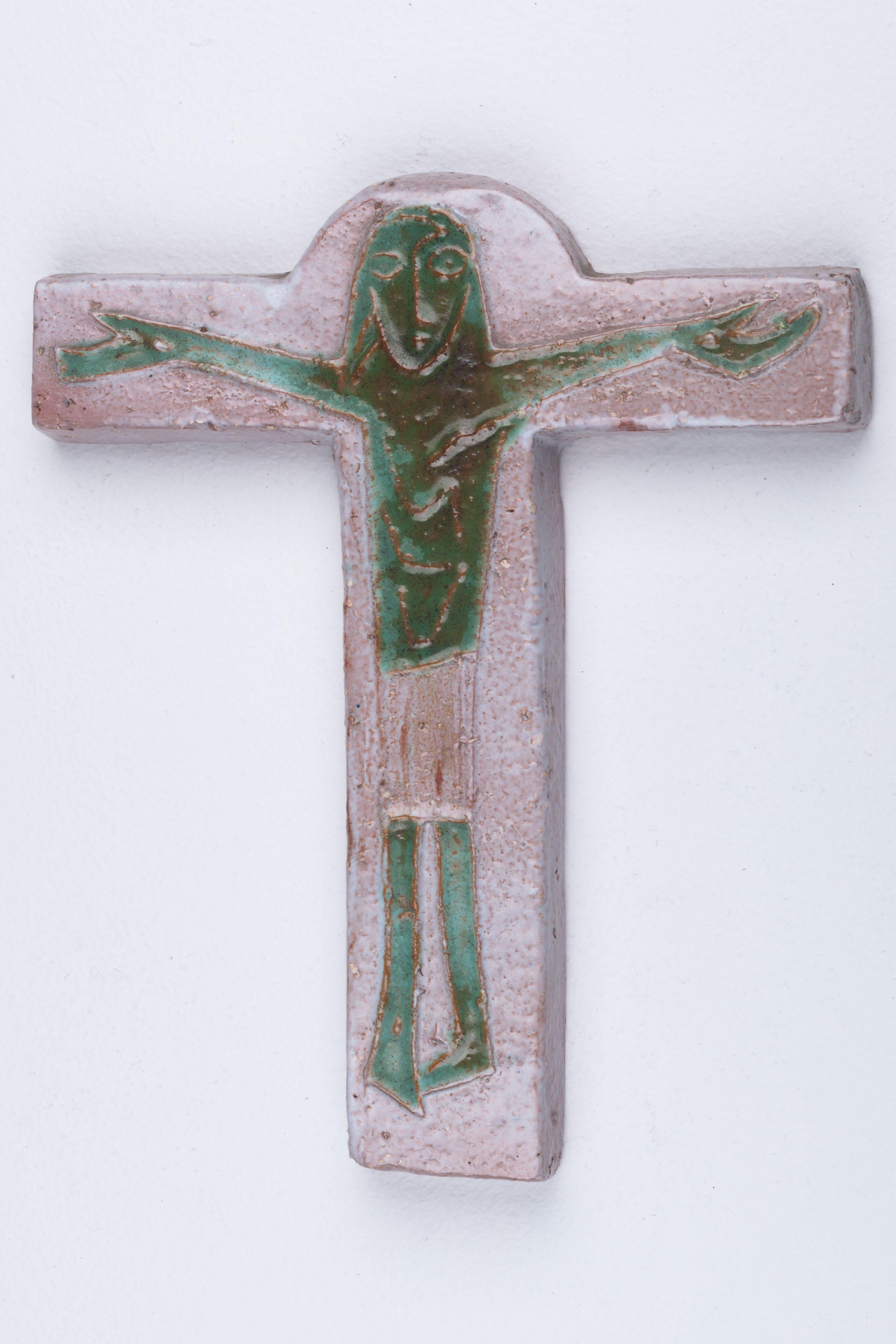 This remarkable midcentury piece crafted in textured, slate-like ceramic, is part of our extensive collection of crosses meticulously handmade by Flemish artisans.

The focal point of this cross is its otherworldly green Christ figure. Its