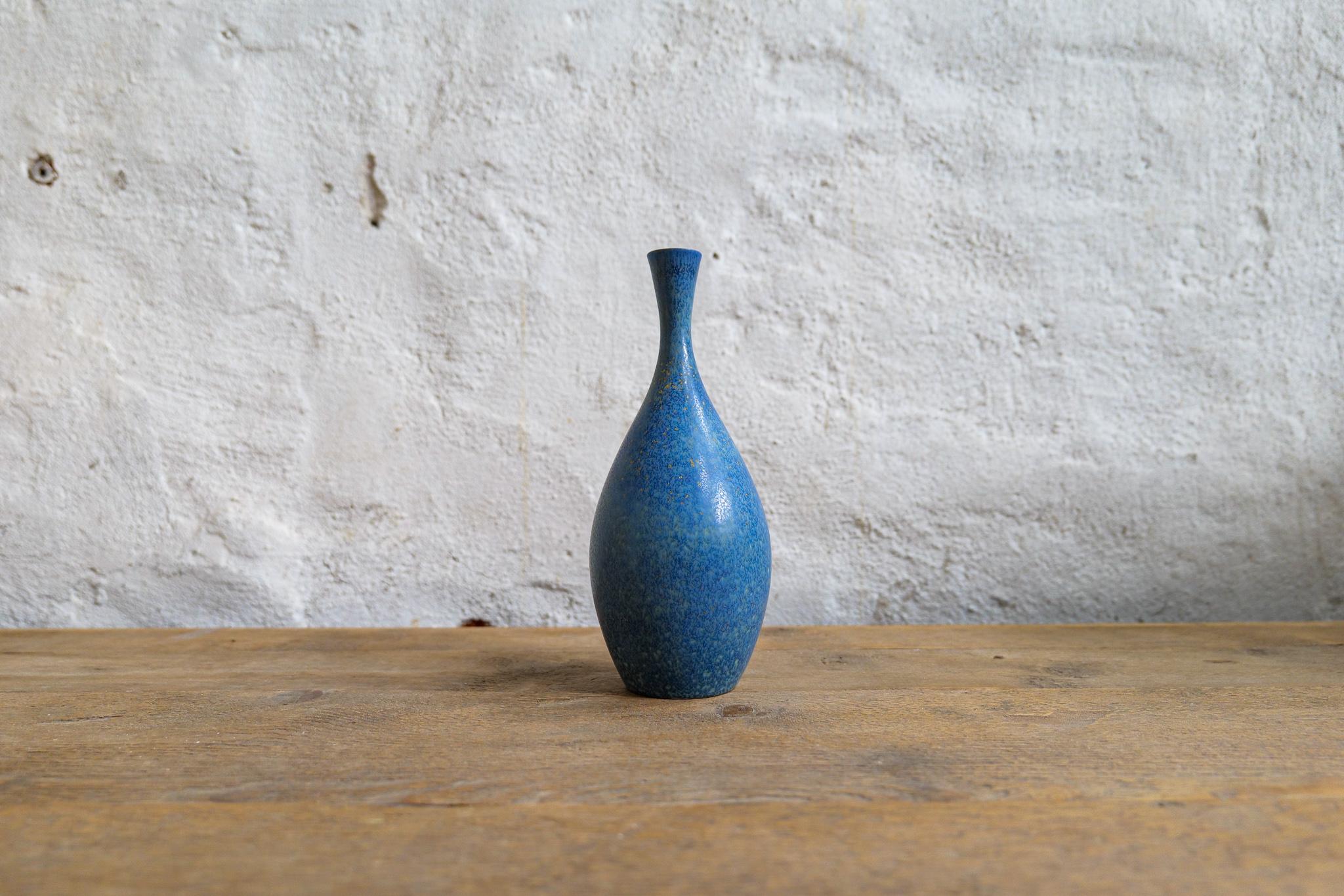 This stunning piece of ceramic was produced at Rörstrand and maker/designer Carl Harry Stålhane. Made in Sweden in the 1950s. Exceptional beautiful blue glazed vases with nice lines. Its rounded bottom with blue glaze and gold/yellow dots, the