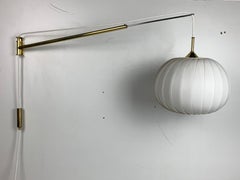 Midcentury extendable brass wall mount with cocoon and sisal shade Lars Schioler
