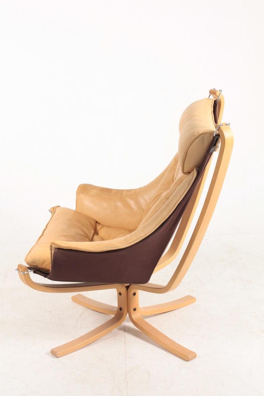Falcon chair in patinated leather designed by Sigurd Resell, made by Vatne Norway in the 1980s. Great original condition.