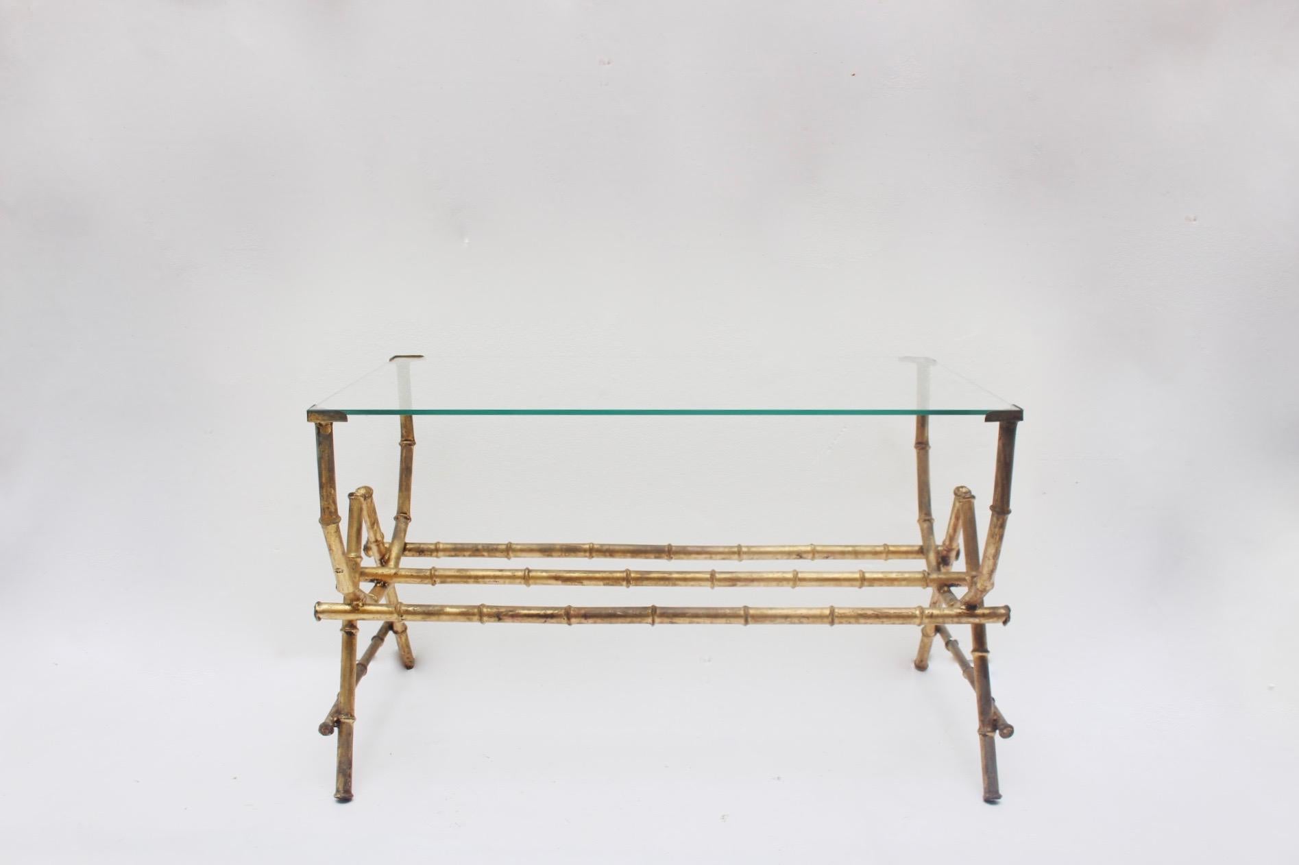 Sculptural midcentury faux bamboo gilt Iron and glass coffee side table, Spain, 1950s.
The piece, remains in good vintage condition, with a patina due to age and use. Glass it is has been added by us, an admits only one position. We don't know if