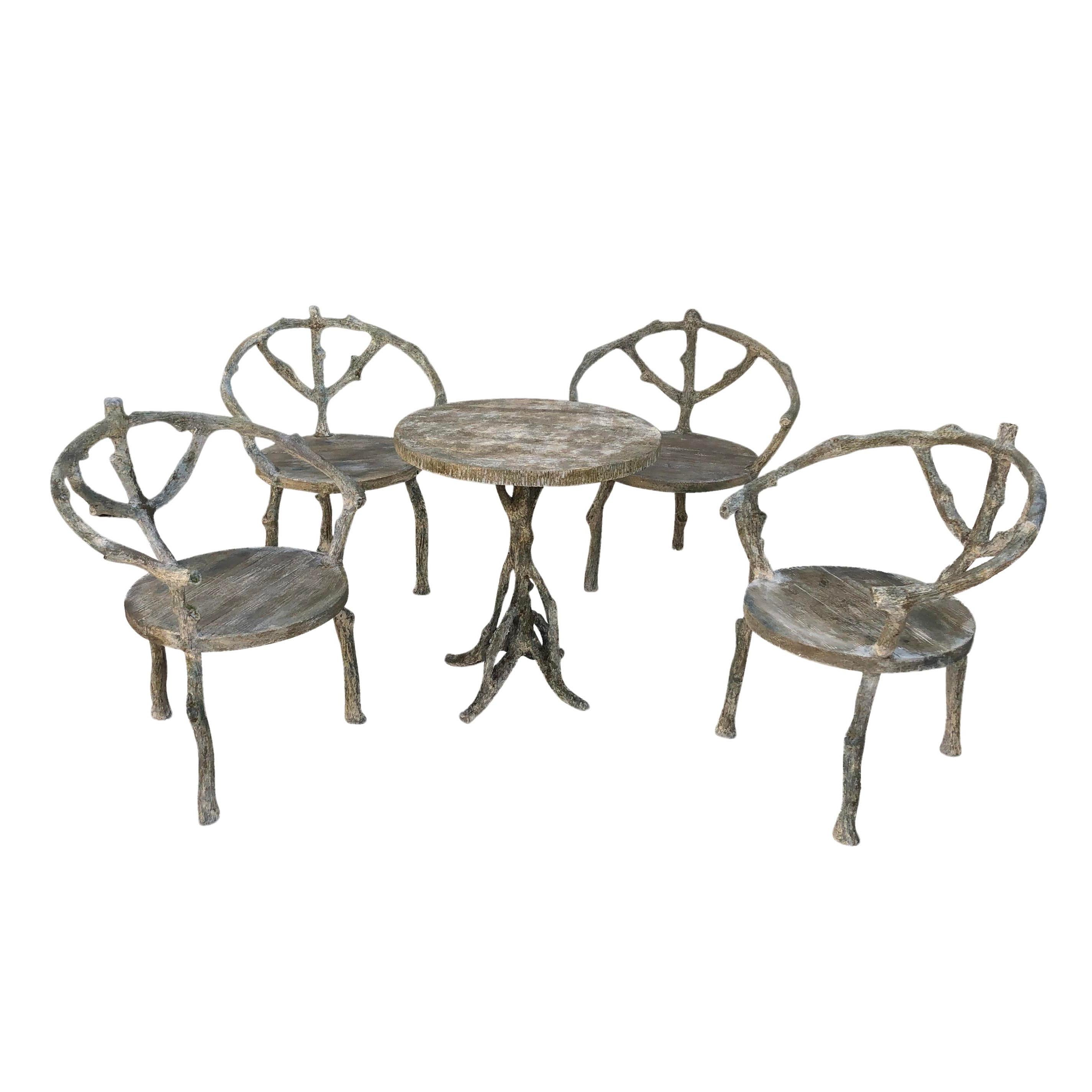 The four chairs with armrests and the round table are designed in the style of Hans Wegner wishbone chair. Very detailed and delicate craftsmanship. A charming special garden decor in excellent condition from France. Naturally aged patina. Wear