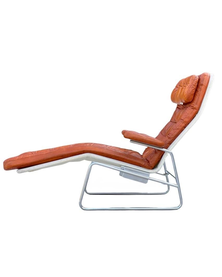 Scandinavian modern reclining chaise lounge chair in chromed steel and cognac leather. Designed by Sam Larsson for DUX, Sweden circa 1970. Definite Bauhaus vibes. Chrome frame is sound and sturdy and free of any pitting. Leather shows a wonderful