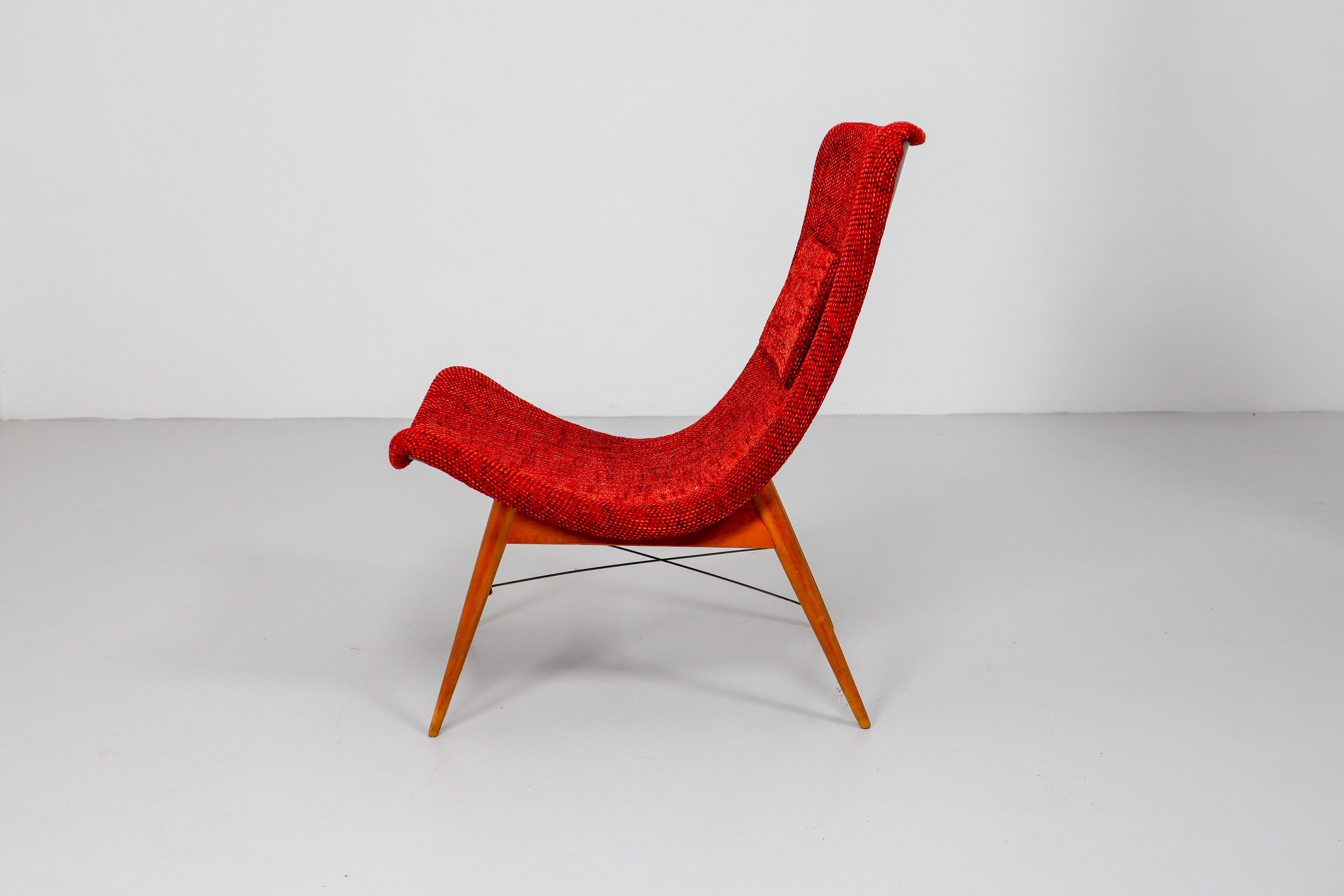 Lounge chairs by Miroslav Navratil, manufactured in former Czechoslovakia by Cesky Nabytek, 1959. Original wooden base, fiberglass shell seating. The backside of the chair is original black color and have a new Reupholstered fabric in strawberry red