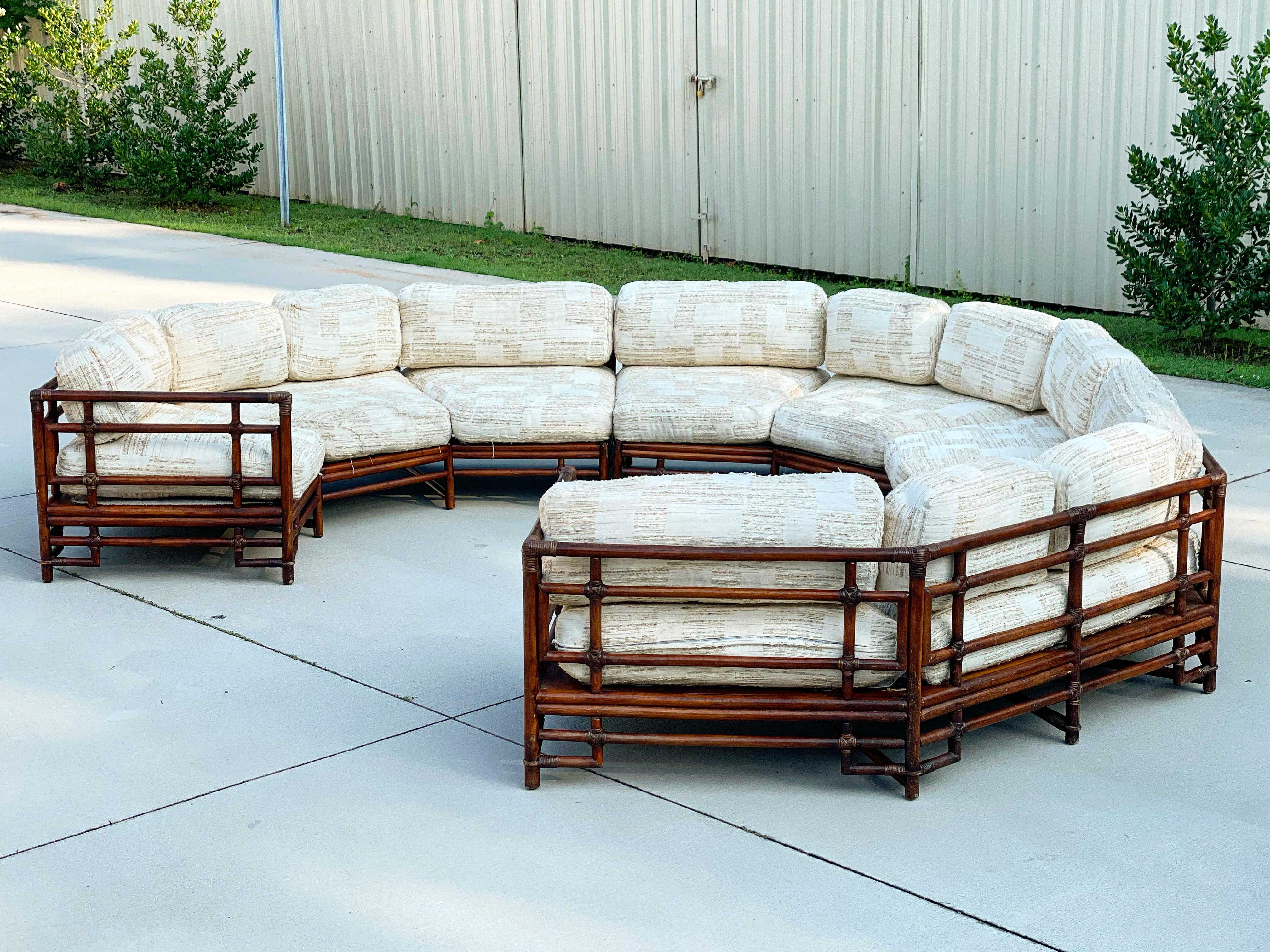 Rare monumental rattan semi circular sectional sofa by Ficks Reed, circa 1975. Pit Group style with seating for 10-12 people. Truly a statement piece and unique on the market. 3 piece sectional sofa. Rattan frame is in excellent condition. It has