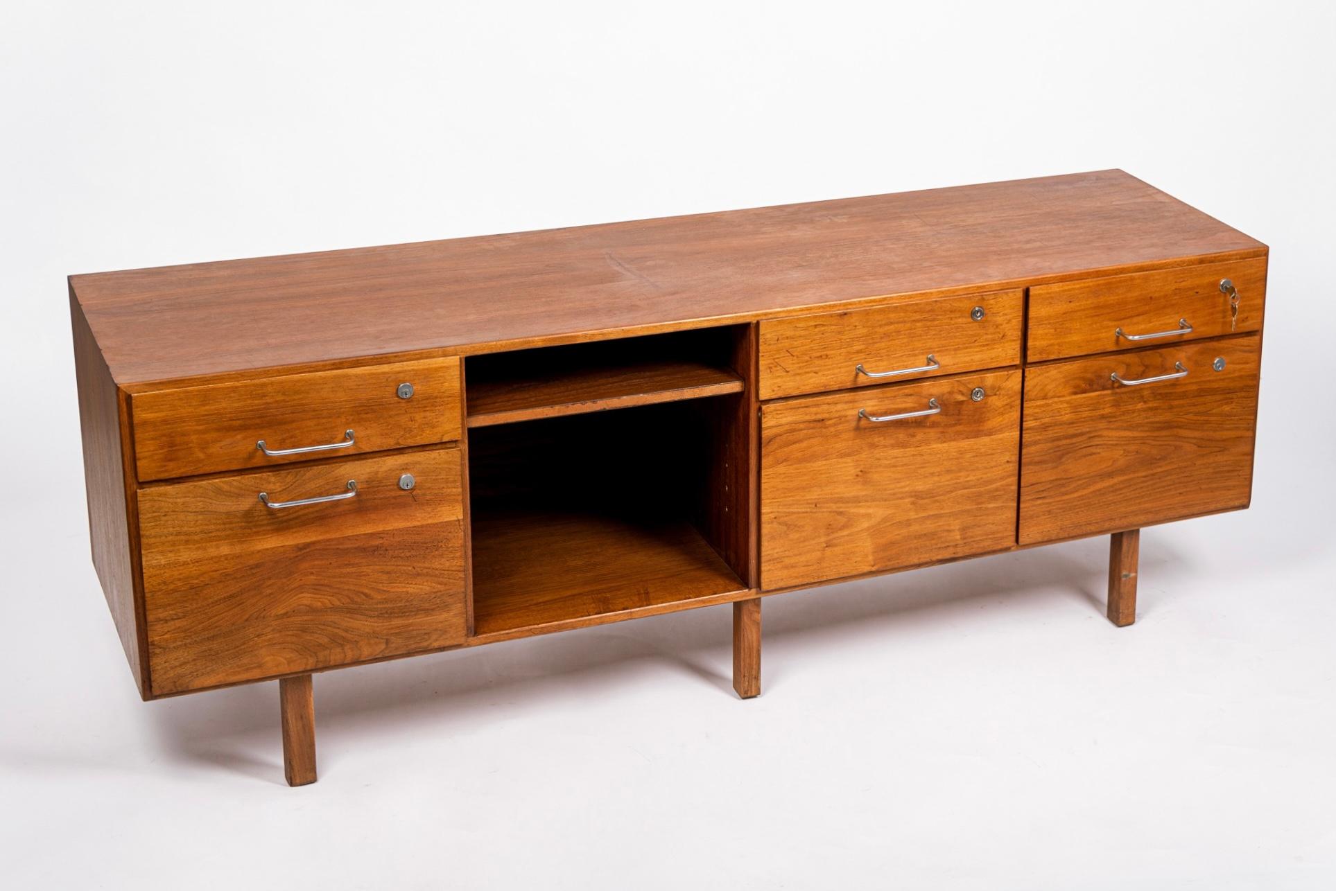 This vintage mid century file cabinet credenza from the Group 8 Collection by Jens Risom circa 1960 has classic Danish modern styling with clean, minimalist, geometric lines. The Group 8 series was made-to-order and highly customizable. This walnut