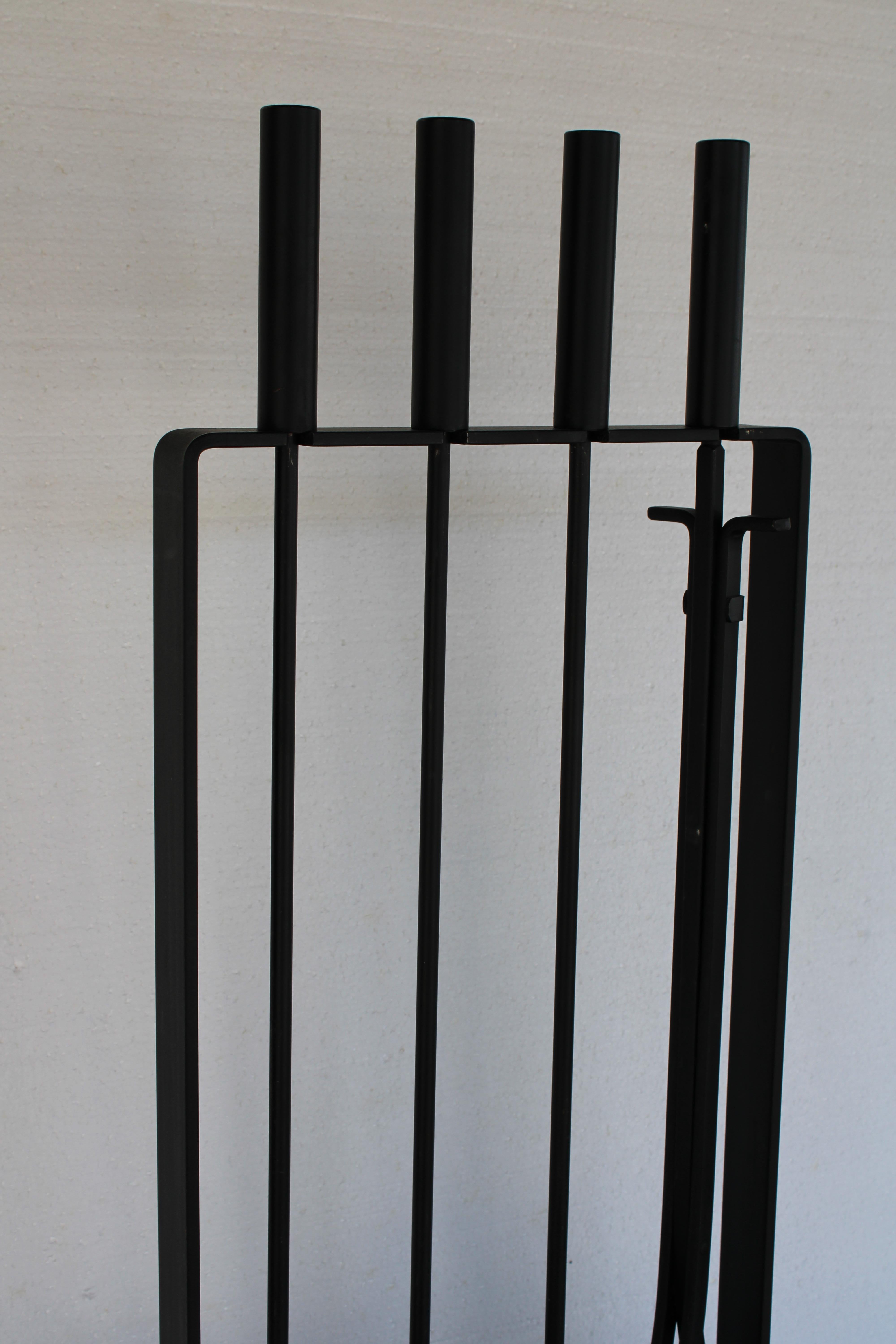 Fire place tool set consisting of a shovel, brush, poker and log grabber. Base is signed Pilgrim Fireplace Manufacturing Co. Total height with tools in place is 32