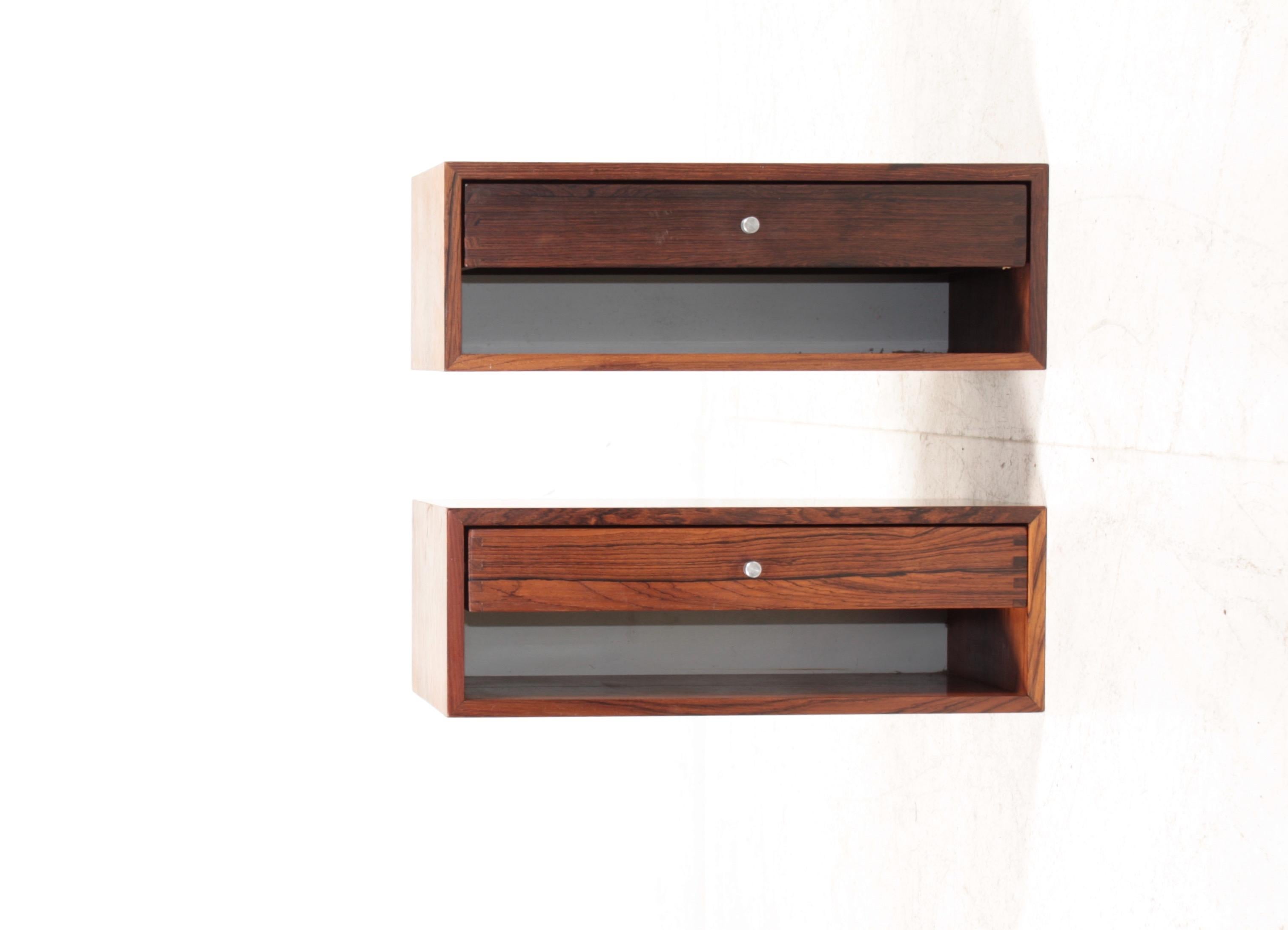 Pair of floating wall nightstands in rosewood with steel hardware. Designed by Danish Kai Kristiansen and made by cabinetmaker Aksel Kjersgaard. Great original condition.

