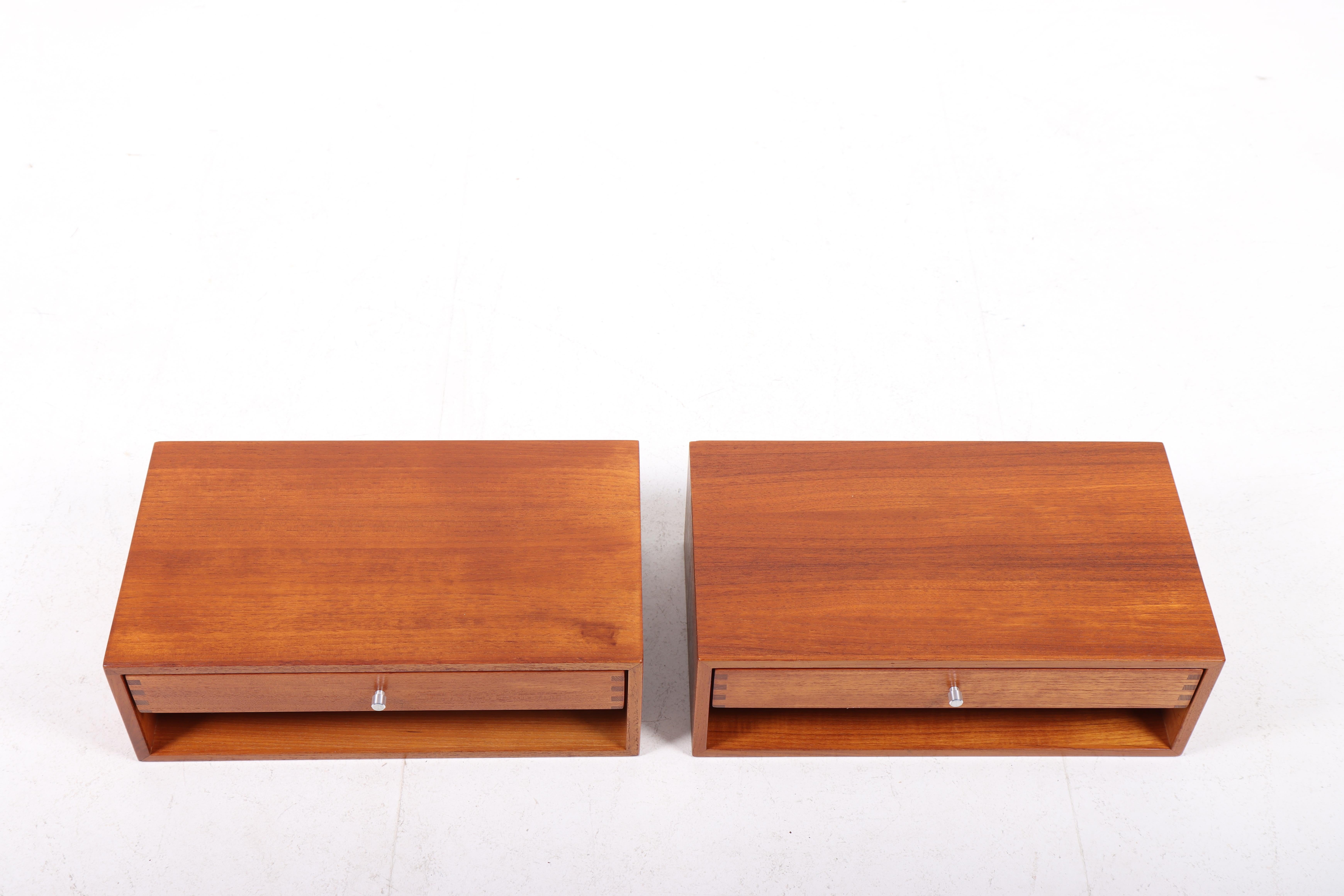 Pair of floating wall nightstands in rosewood with steel hardware. Designed by Danish Kai Kristiansen and made by cabinetmaker Aksel Kjersgaard. Great original condition.

