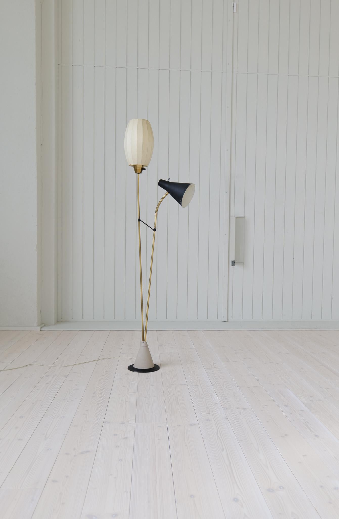 Genuinely nice Swedish floor lamp made in Sweden for Ateljé Lyktan and attributed to Hans Bergström. The base is made with iron casting and continues with brass. The two-light sources itself are the original shades made from plastic and a