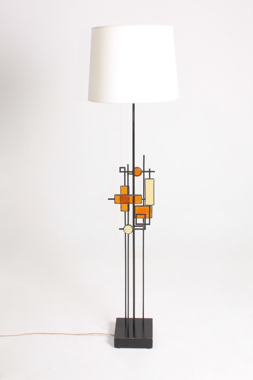 Floor lamp in metal and art glass on a wood base, designed and made by Svend Aage Holm Sorensen. Great original condition.