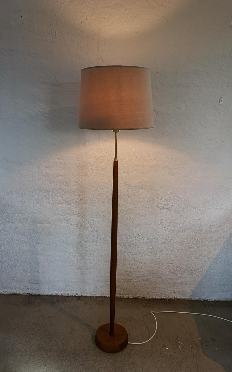 This lamp was made in Sweden at Falkenbergs Belysning. The combining of brass and teak makes this lamp a nice edition to any room.

Good working condition. The shade in velvet is not original it’s a new and comes with the purchase of the lamp. New