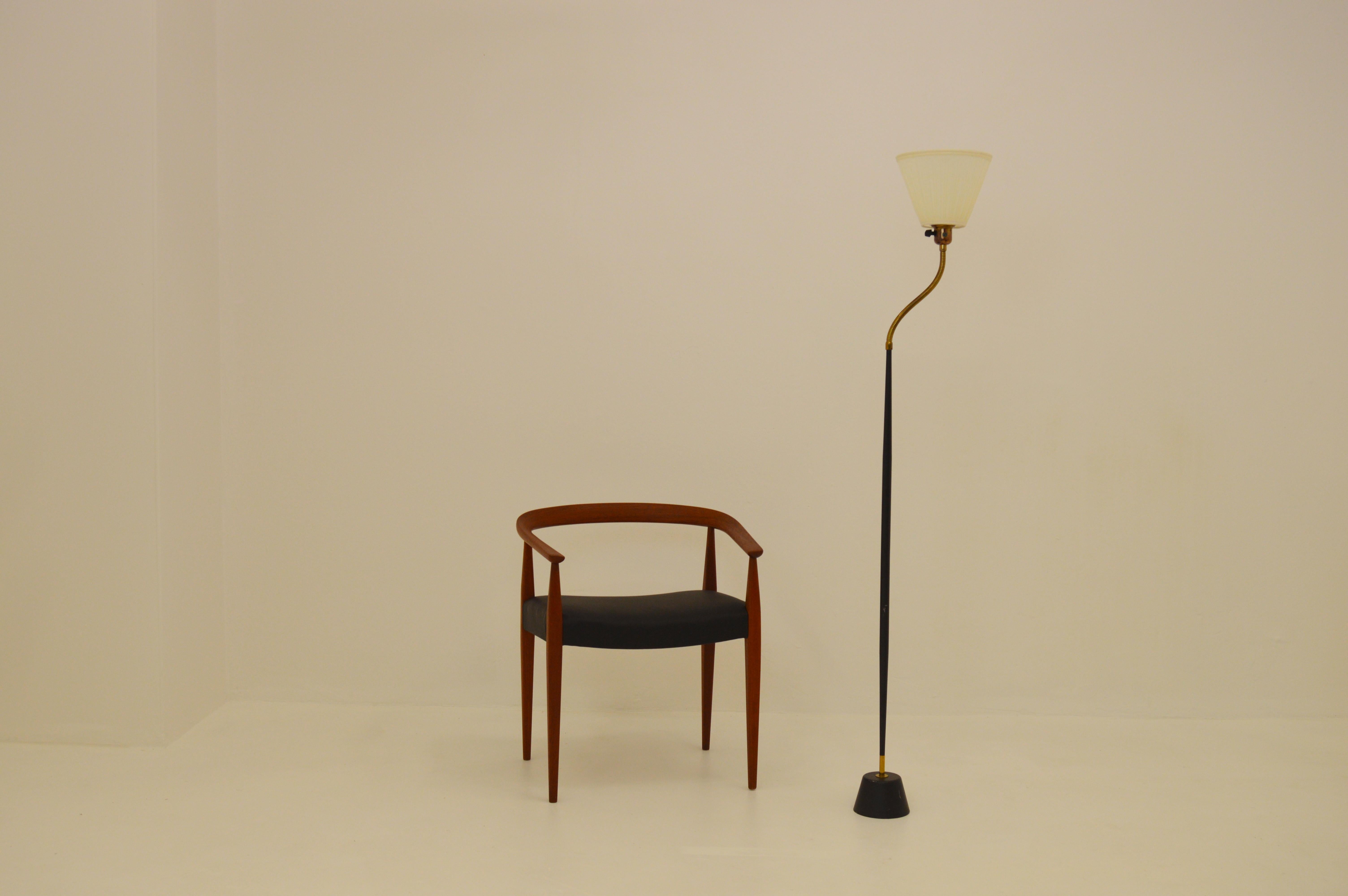 Rare Scandinavian Modern floor lamp. Cone shaped bar, and black lacquered metal with an adjustable brass arm. Produced for ASEA by unknown designer. Lampshade made by fabric with plastic inside.
Measurements below is the foot base diameter and