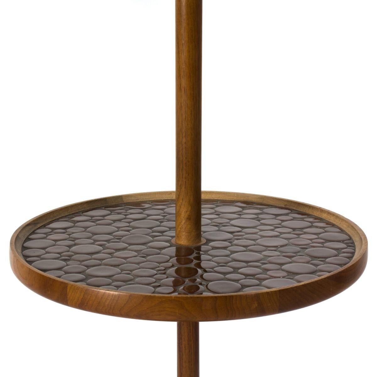 Floor lamp with inlaid ceramic tile top table by Jane and Gordon Martz for Marshall Studios. Includes custom oversize linen shade, USA, circa 1950.

Dimensions: 60 inches H x 19 inches base W x 29 inch shade W.
 