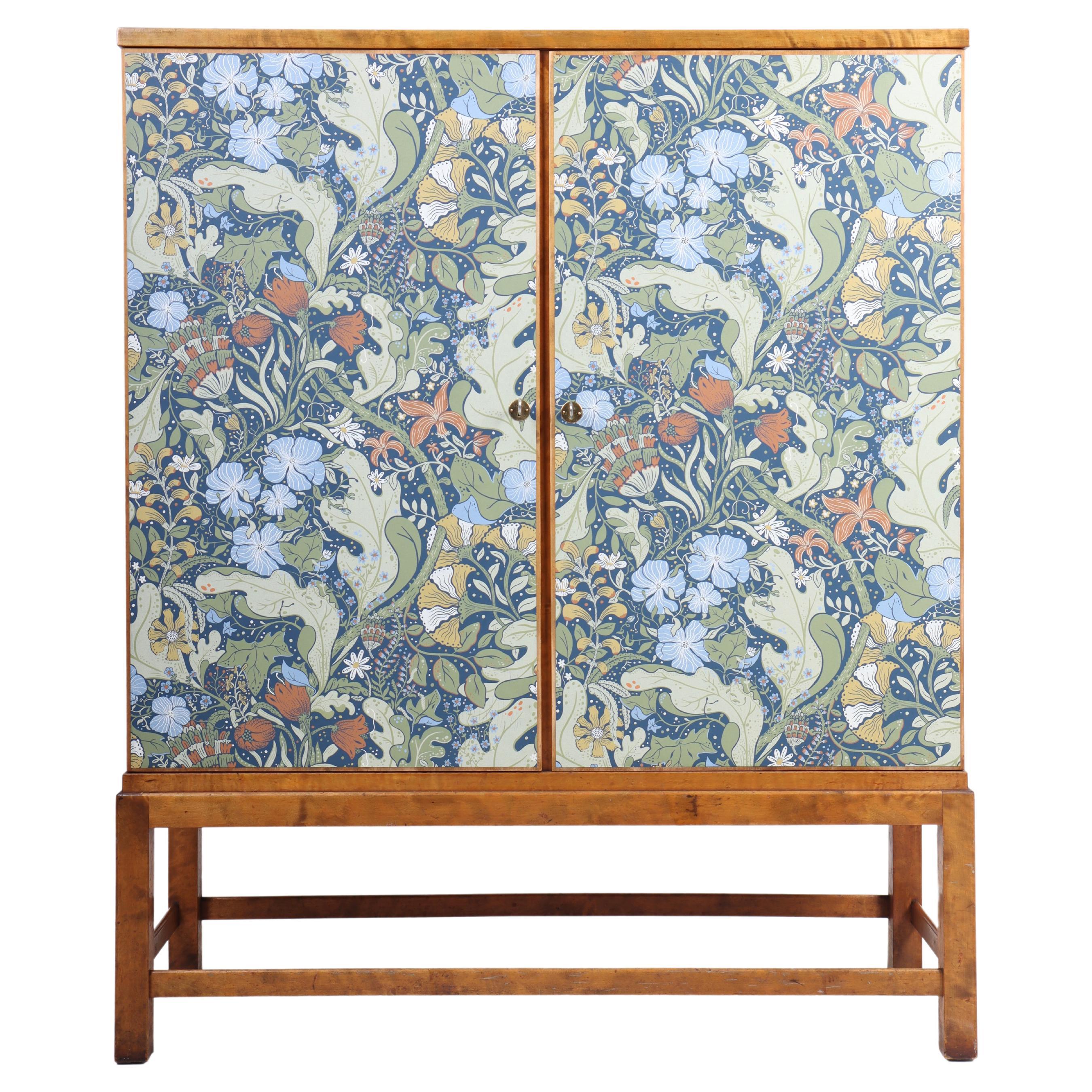 Cabinet features two locking doors, removeable trays and shelves. Designed and made in Sweden, 1940s.
