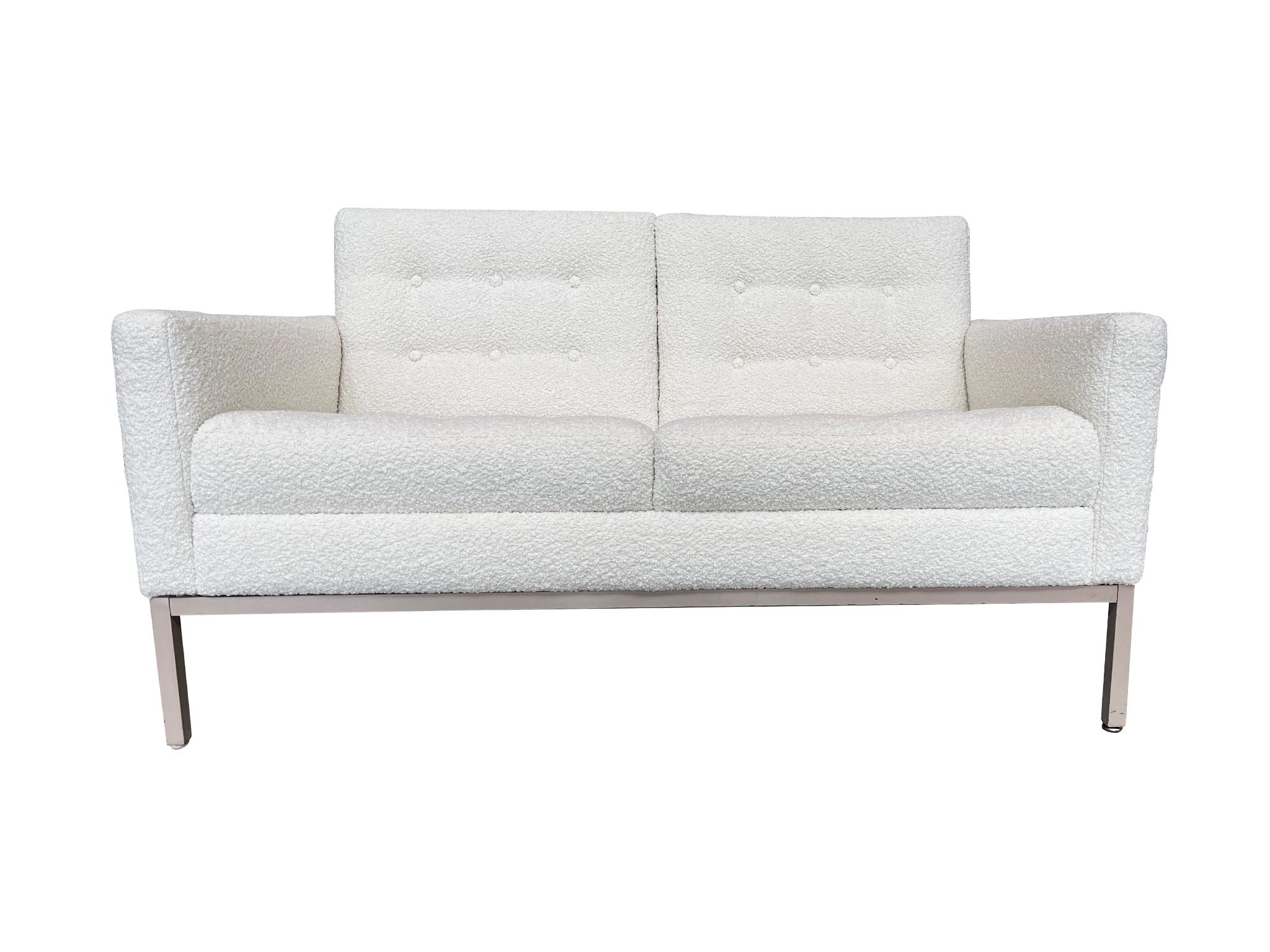 Originally made in the 1970s, this two-seater settee by Patrician Furniture Company takes after the iconic Florence Knoll sofa, with its combination of angular and soft lines. The settee has been newly reupholstered in white chenille with button