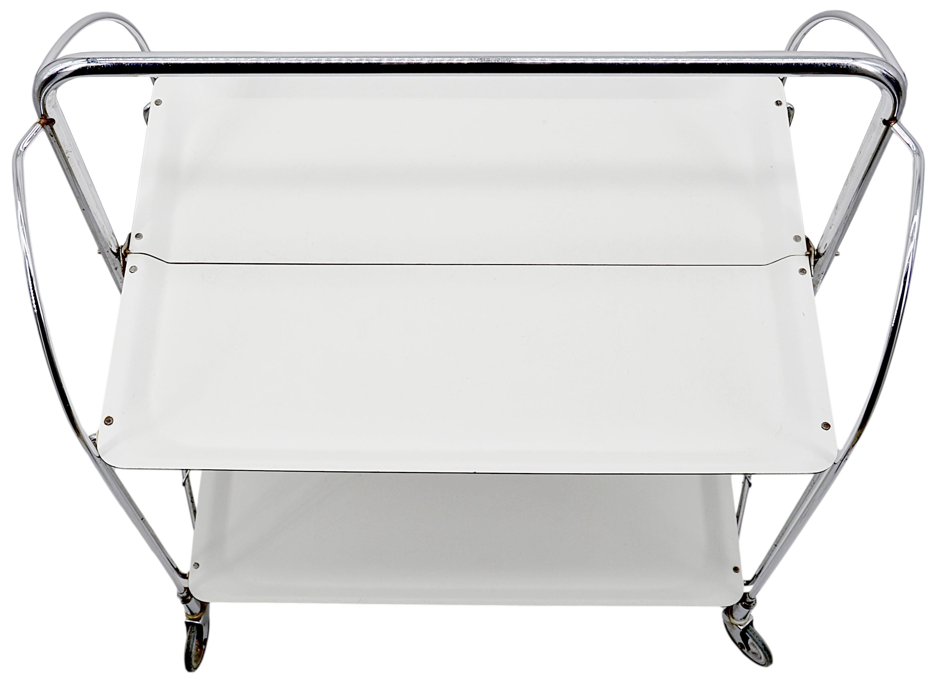 Midcentury serving trolley table, Germany, 1960s. Folding table. Chrome, metal and plastic. Measures: Height 30.3