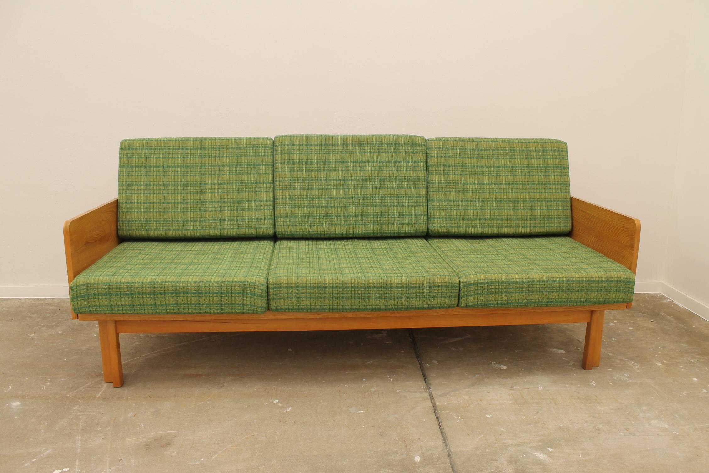 Midcentury sofa bed,made by Jitona company in the former Czechoslovakia in the 1970s. The sofa has a beechwood structure and green upholstery, it´s in excellent Vintage condition, showing slight signs of age and using.

Measures : 
Lenght: 199