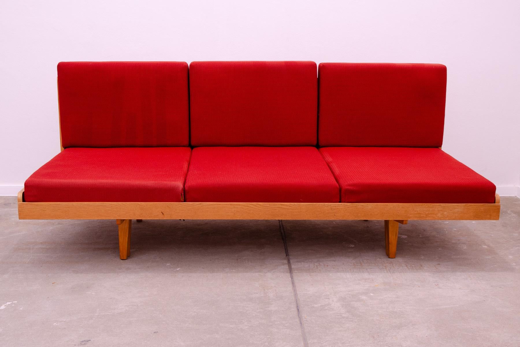 Midcentury sofa bed, made by Jitona company in the former Czechoslovakia in the 1970s. The sofa is made of beech wood and ash wood and has an original upholstery. The sofa is in a very well-preserved and good condition, however, it bears reasonable