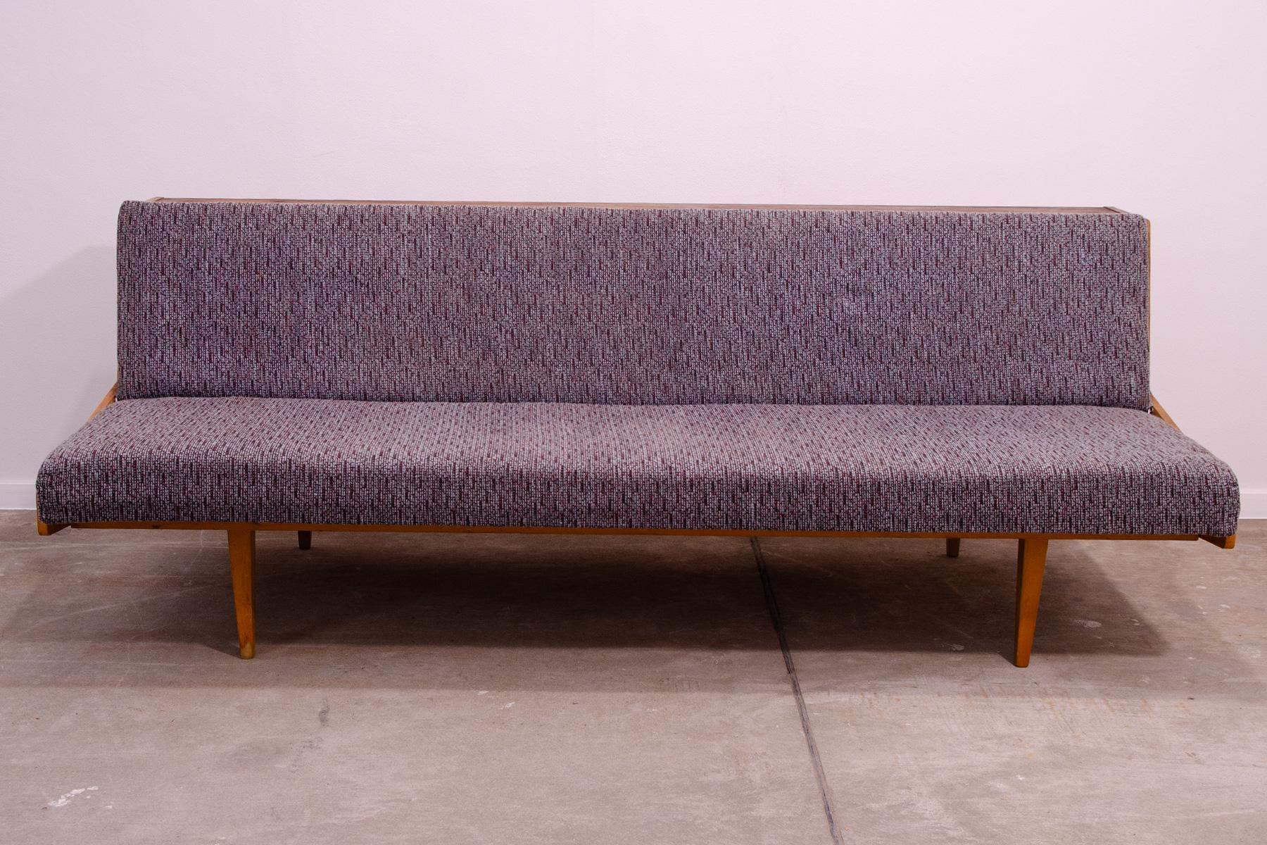 Midcentury sofa bed made in the former Czechoslovakia in the 1970s. It was made by Tatra nábytok company. The sofa has a wooden structure with ash wood veneer, overall it´s in good Vintage condition, the cushions show signs of age and