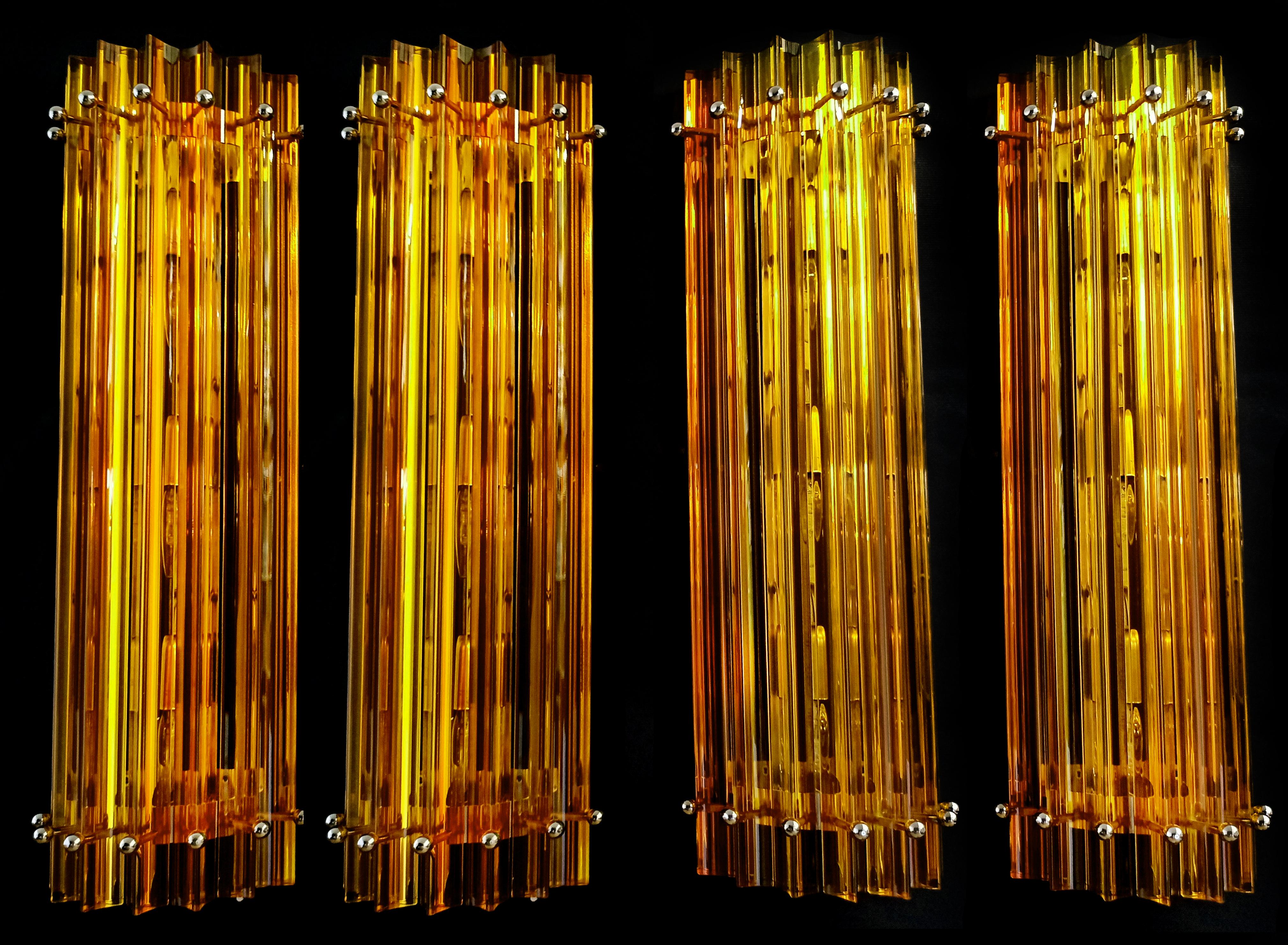 Four Murano wall sconces, amber triedri, column Mariangela model
Fantastic Trio of vintage Murano wall sconce made by 6 Murano crystal prism (triedri) for each appliqué in a chrome metal frame. The shape of this sconce is column. The glasses are
