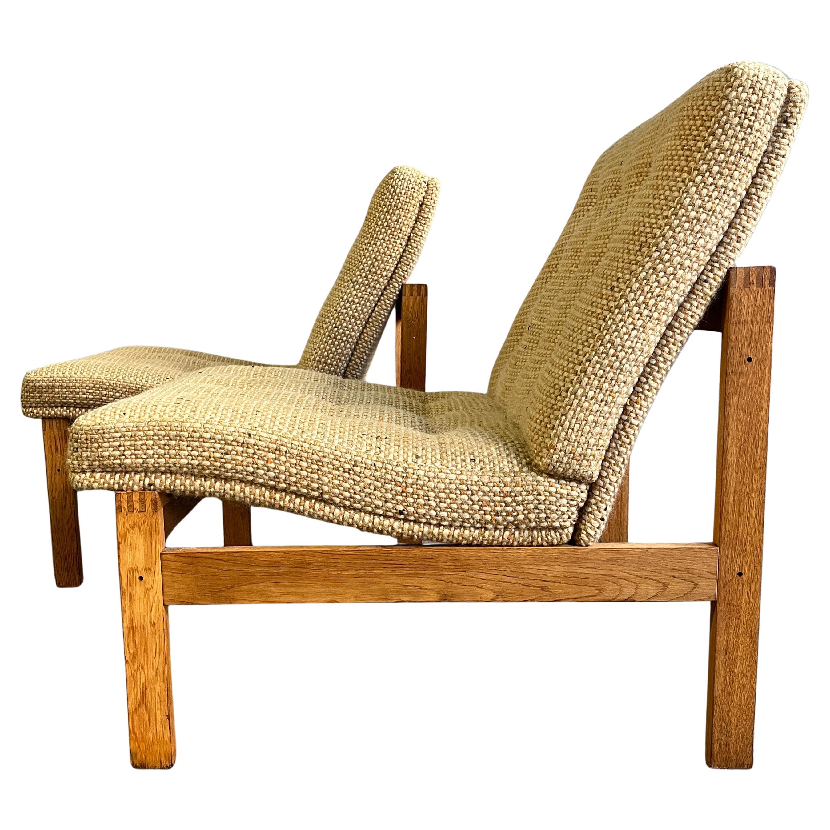 Stylish easy chair by Ole Gjerløv-Knudsen and Torben Lind for France & Son Denmark. Very good condition with oak frame and original wool upholstery. Signed with manufacturer's mark Cado and France & Son. 