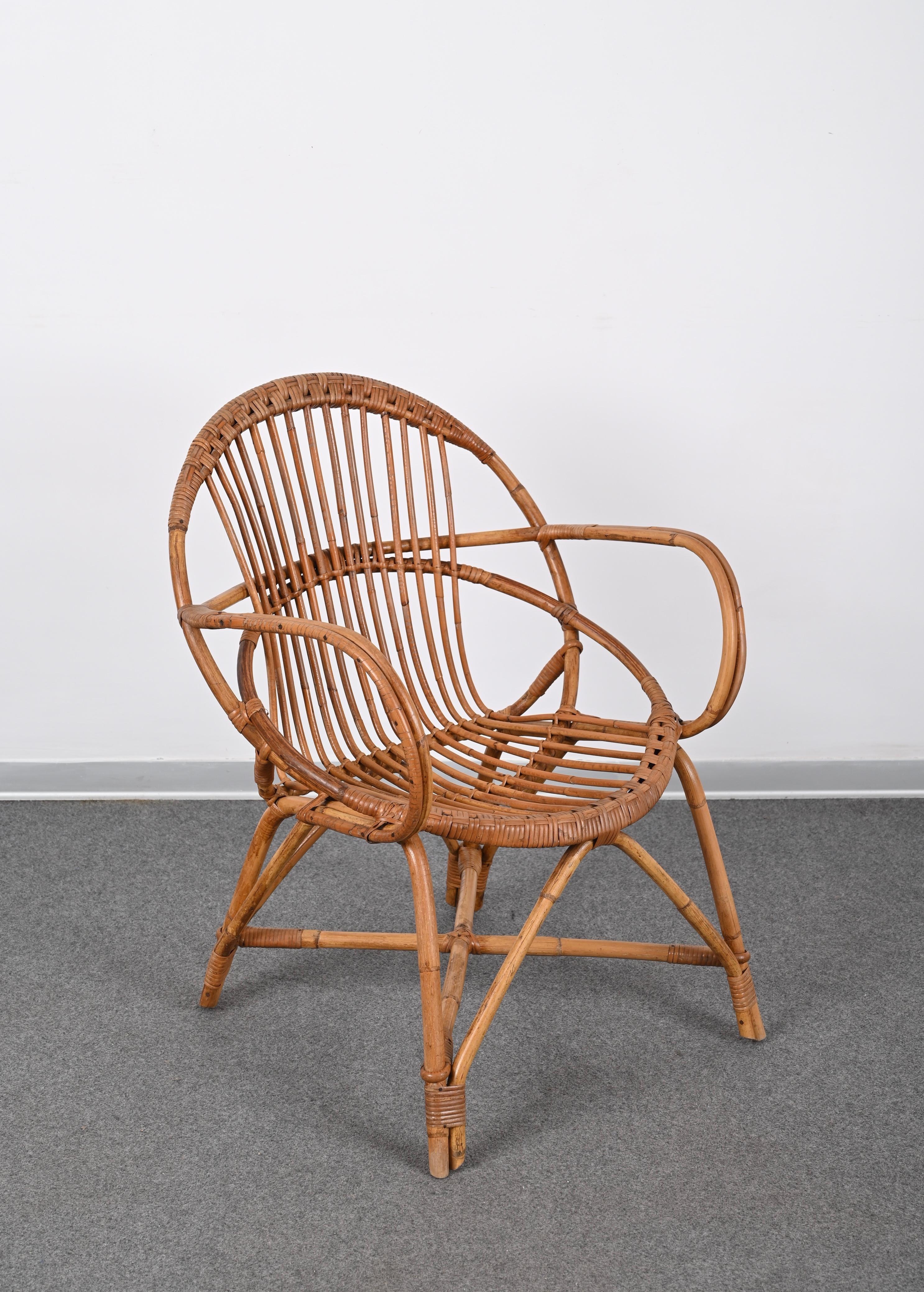 Amazing midcentury Rattan shell armchair. This piece was produced in Italy in the 1950s and is attributed to the mastery of Franco Albini.

The uniqueness of this armchair is due to the solid shell shape of the handmade rattan seat that will