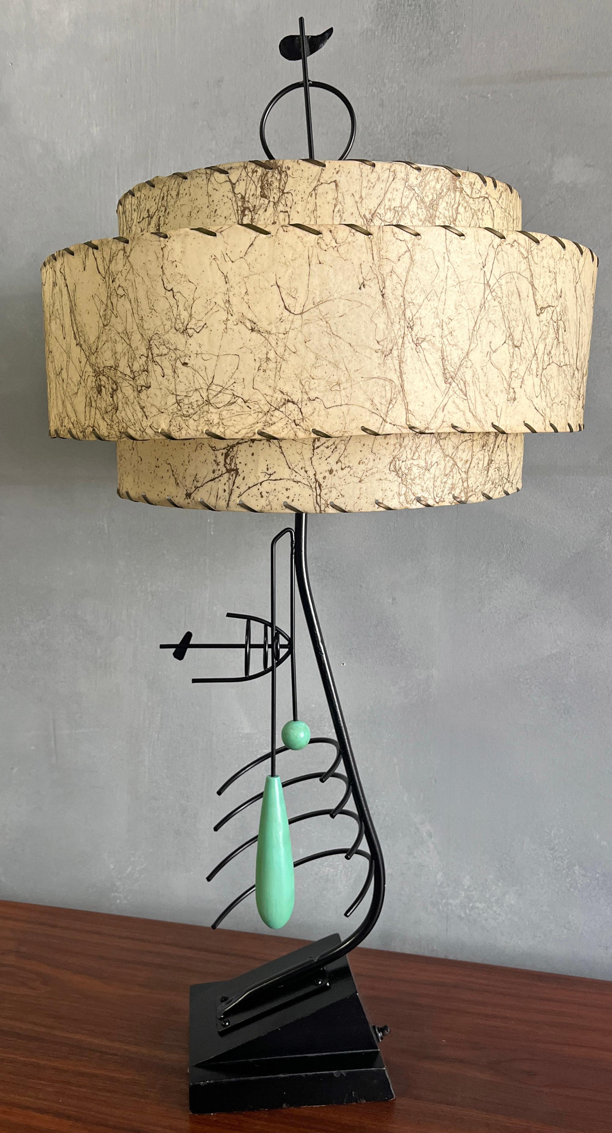 Gorgeous sculpted lamp with painted metal and wood forms akin to Miro. Black and seafoam green base together with original three tier shade proves to be a mid-century stunner. Toped with a custom Finial. Hand made by framed artist / designer. In