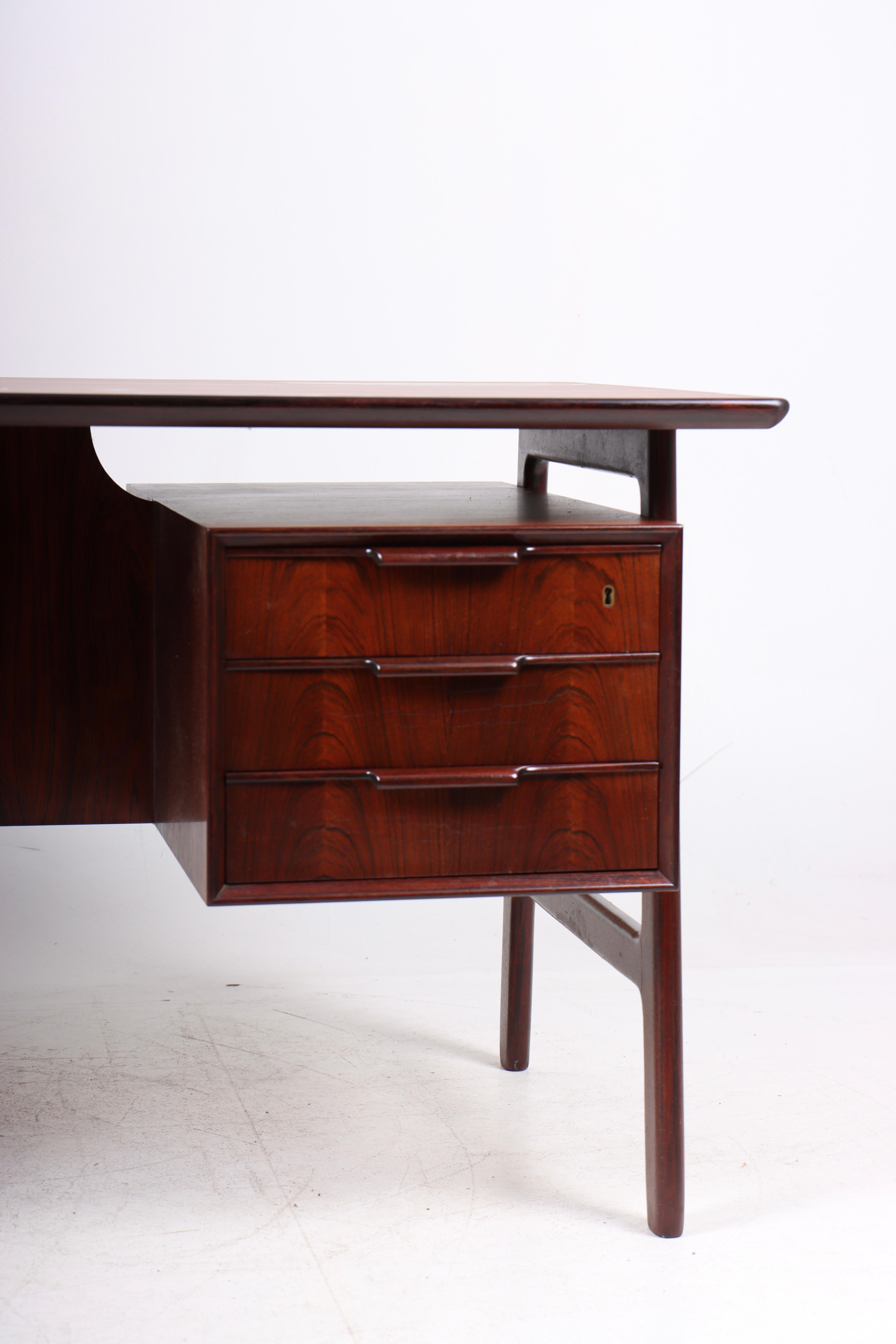 Great looking freestanding desk in rosewood designed by Gunni Oman for Oman Jun, Denmark in 1957. Great original condition.