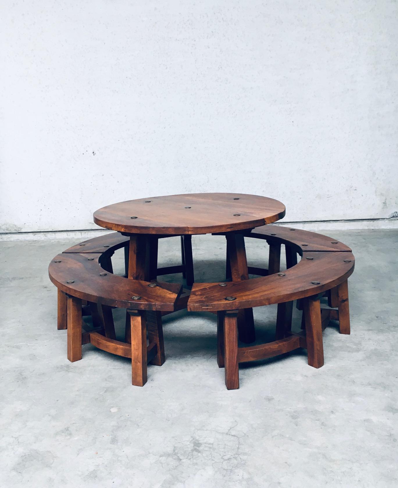 Vintage Midcentury Chalet style round dining table with four matching benches. Made in France, 1950's / 60's period. In the style of Pierre Chapo designer. Hand crafted in solid hardwood (Elm or Ash) with trestle bases and forged iron hardware on