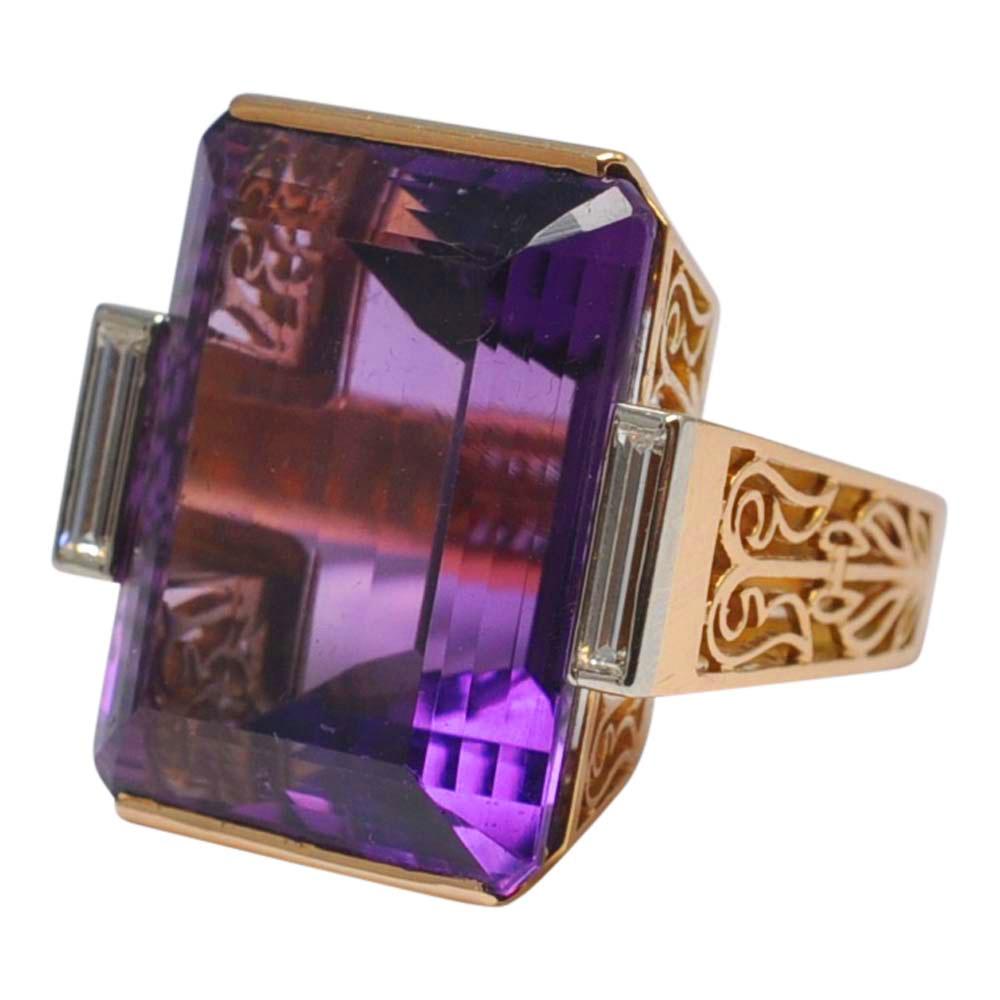 Spectacular French mid-century amethyst cocktail ring; this ring is a real statement piece and was made by the French jeweller Raymond Dubois in the 1950s.  The amethyst weighs 35.5cts and is a rich deep purple, accented by two baguette diamonds