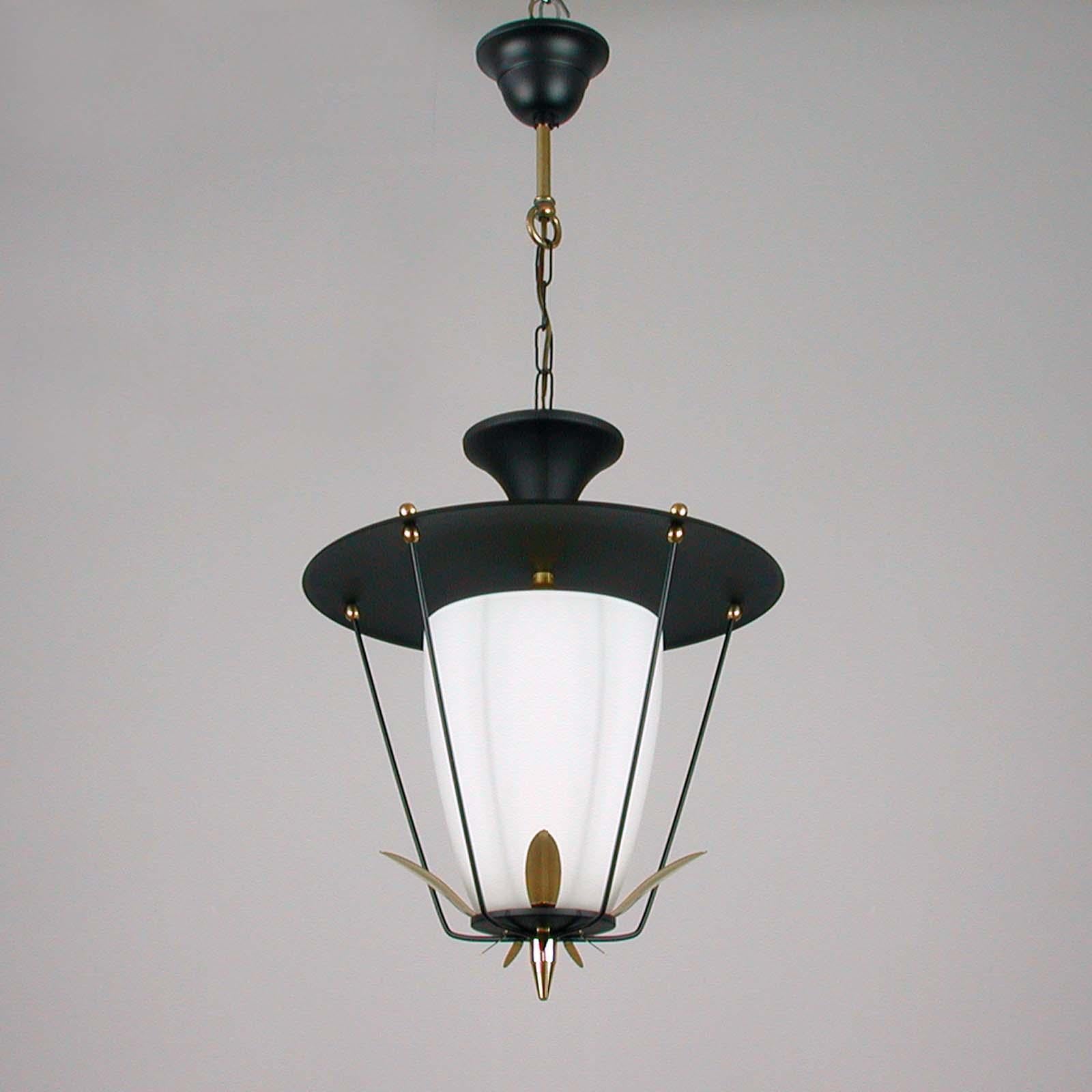 This vintage Maison Arlus / Lunel style lantern / ceiling light was designed and manufactured in France in the 1950s. It features a black lacquered metal lampshade, black case with a white frosted glass diffuser and brass details. 

The lantern