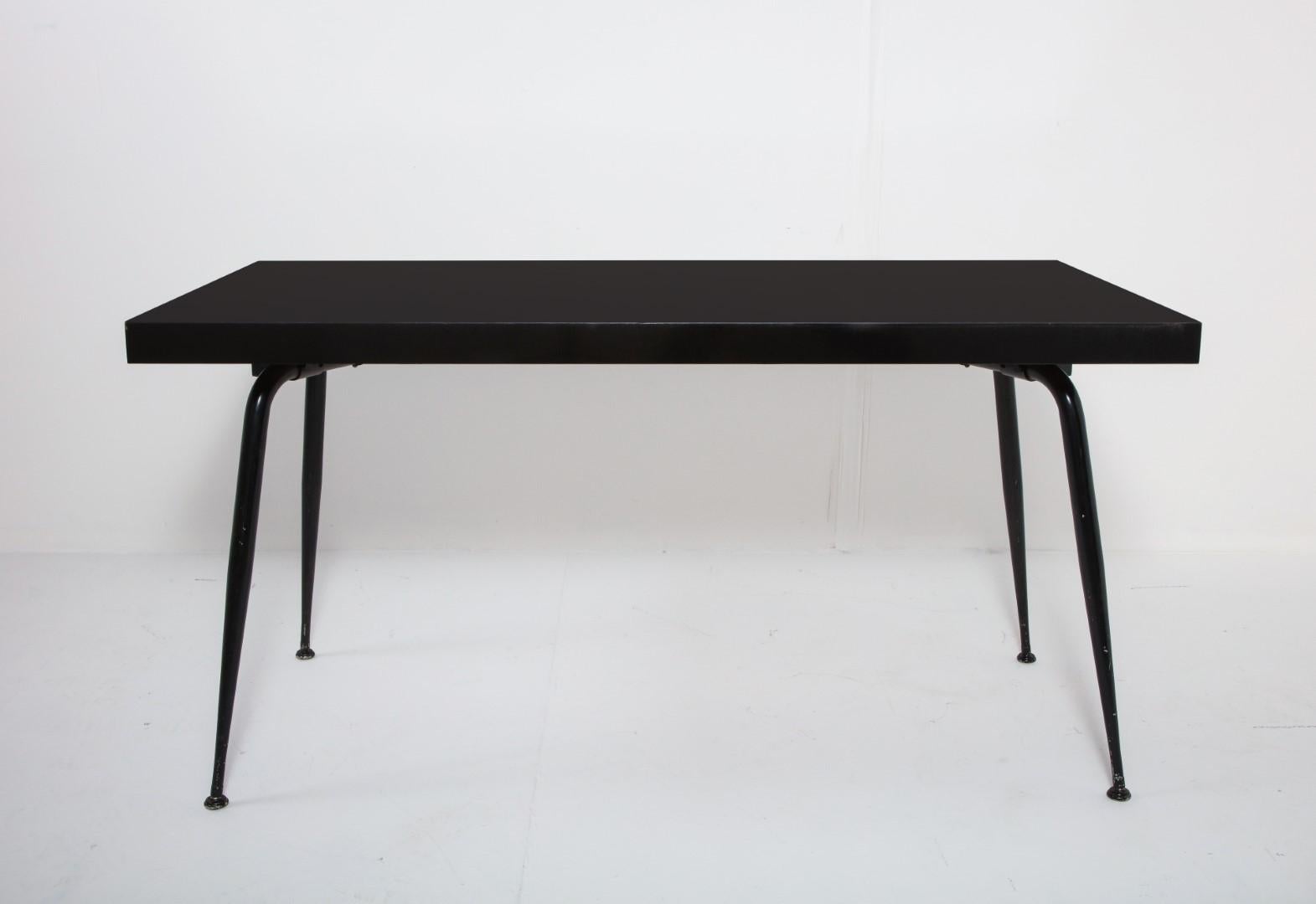 1950s French desk with iron legs and durable black composite top. Top is 2.25