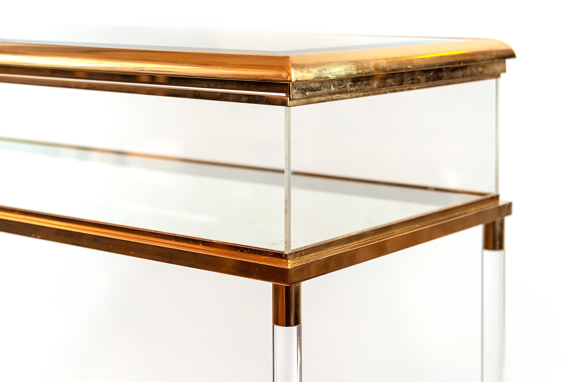 This midcentury French console table - showcase with glass top, plexi glass legs, brass frame, polished golden color finish. The top of it is sliding to one side.