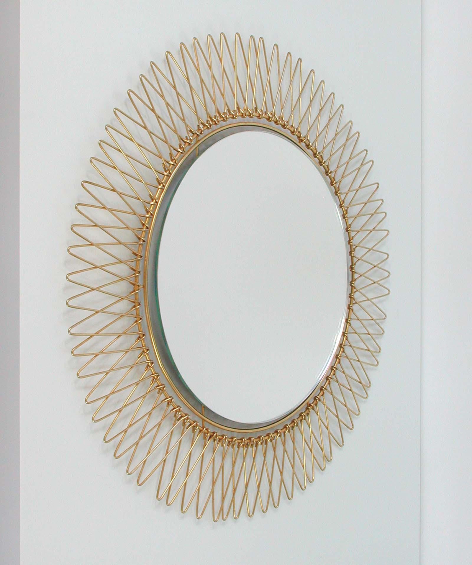 This round brass sunburst mirror was made in France in the 1950s. 
Diameter of mirror only (without frame) is 11.5