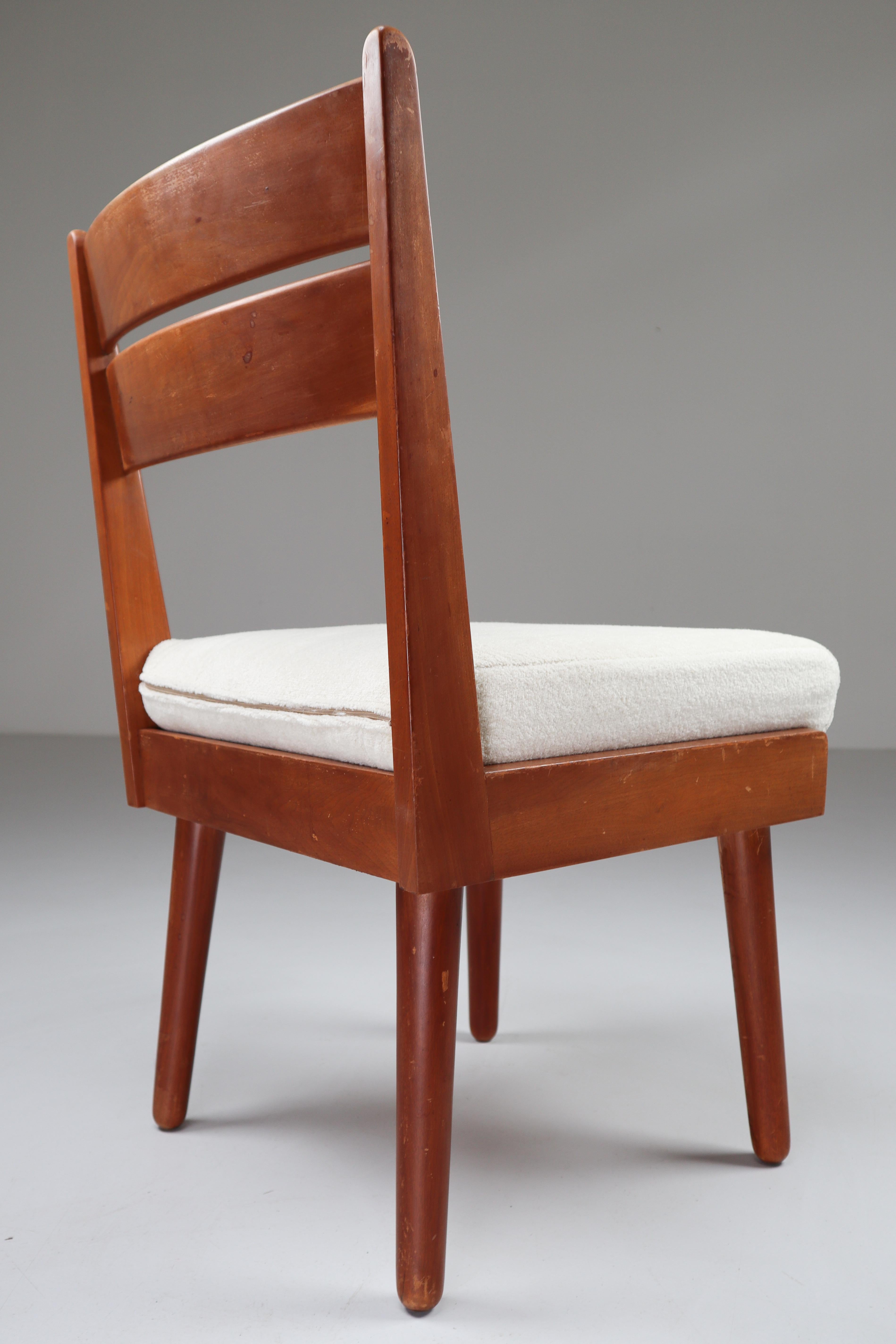 Chairs in solid walnut and re-upholstery crème, white Fabric from France, 1950s. These chairs would make an eye-catching addition to any interior such as living room, family room, screening room or even in the office. It also perfectly fits in a