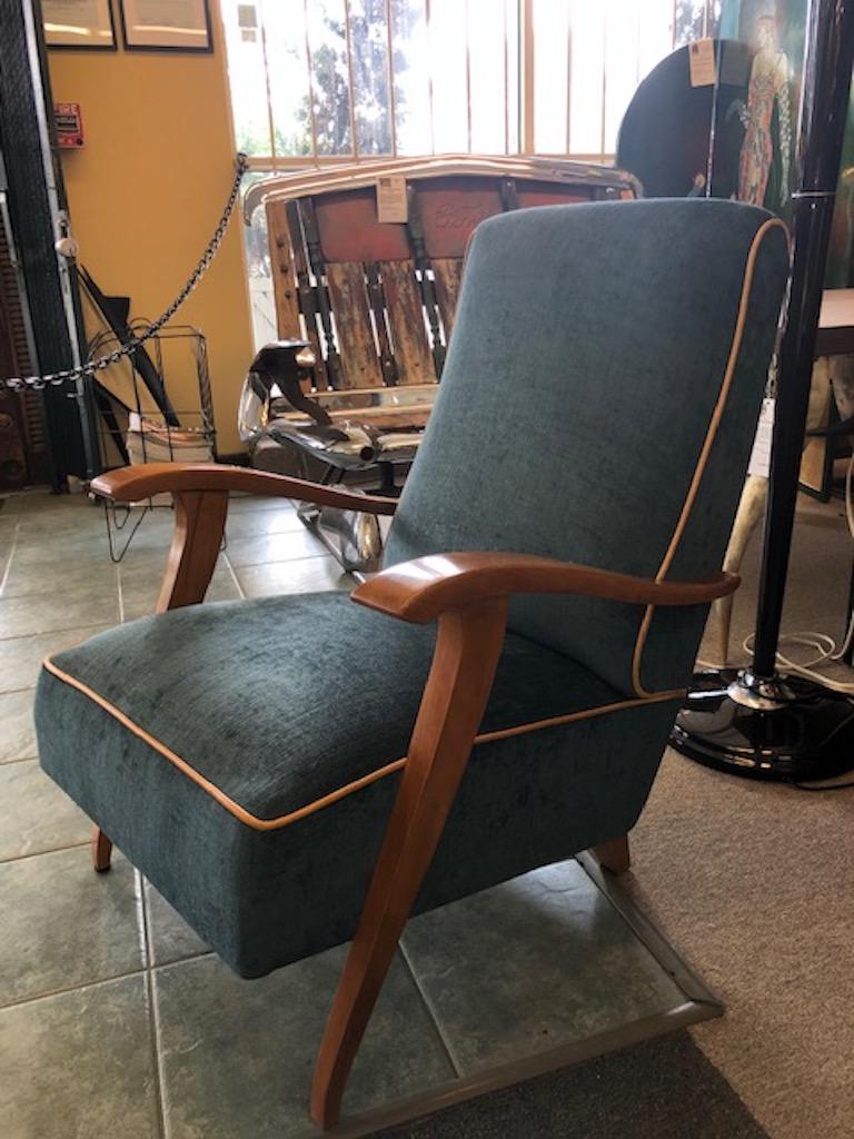 Each chair is newly re-upholstered in blue velvety fabric. Body of the chair is made out of beech wood. Back part of the chair is elevated be the small square legs. Front is elevated by skinny elongated legs that are connected to the bottom of each