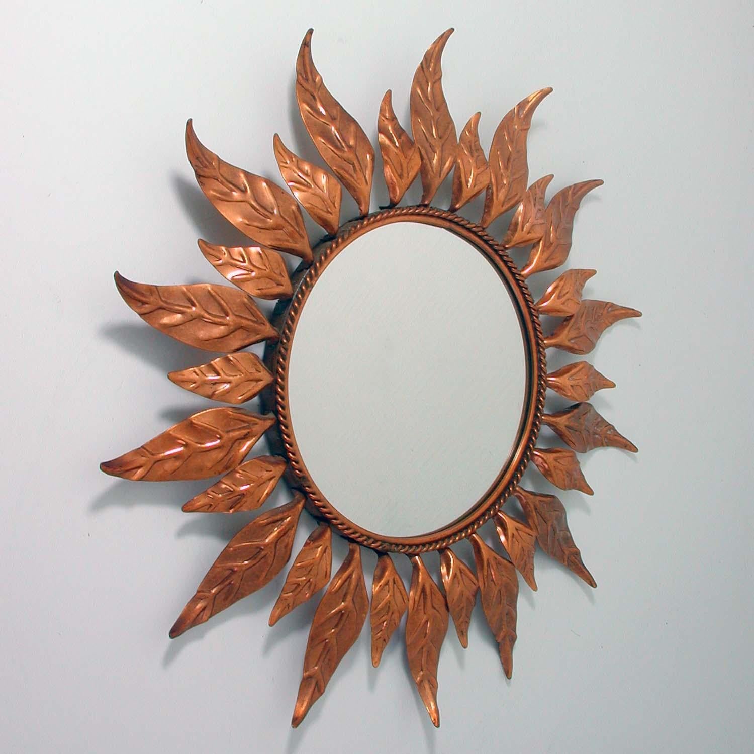 This round copper sunburst mirror was made in France in the 1950s. 
Diameter of mirror only is 8.7