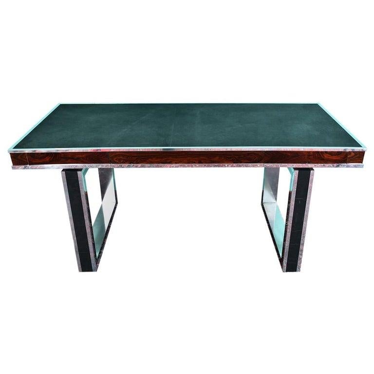 Mid-century French desk

Desk is rectangular table top, re-upholstered in a new graphite cowhide. It has a chrome trimming at the edges and beautiful wood grain is displaying on the sides of the table top. 2 legs are made as a rectangular with an