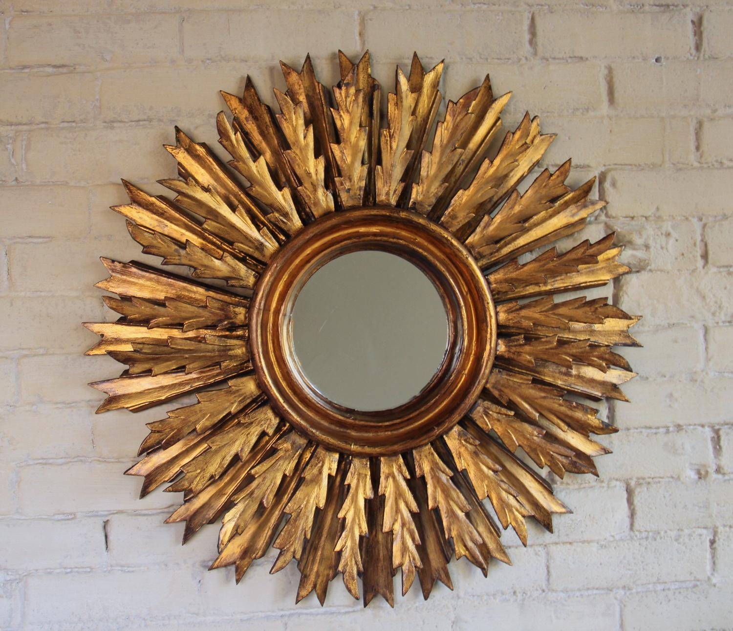 An impressive midcentury French sunburst mirror, circa 1930 with rays arranged in a double layer pattern. Original mirror plate. The mirror is 7.5 inches in diameter.