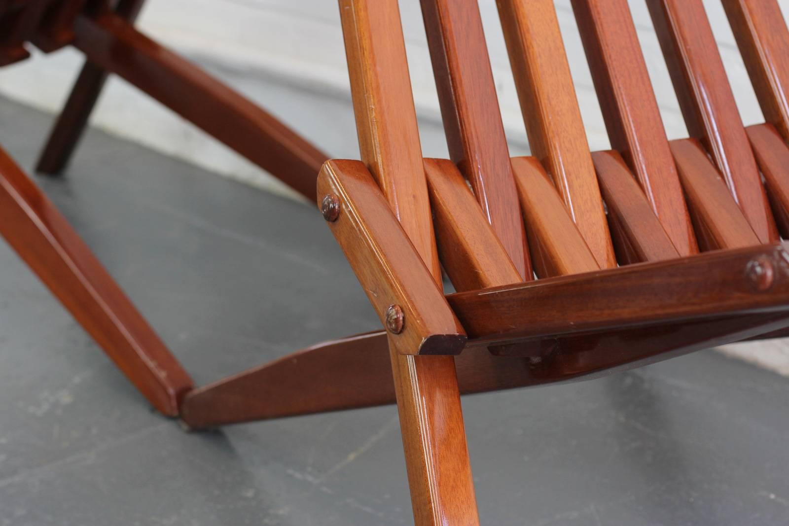 Midcentury French folding teak chairs 

- Price is per chair (2 available)
- Thick teak slats with a high gloss finish
- French, circa 1970s
- Measures: 52 cm wide x 89 cm deep x 87 cm tall
- 32 cm from floor to seat

Condition