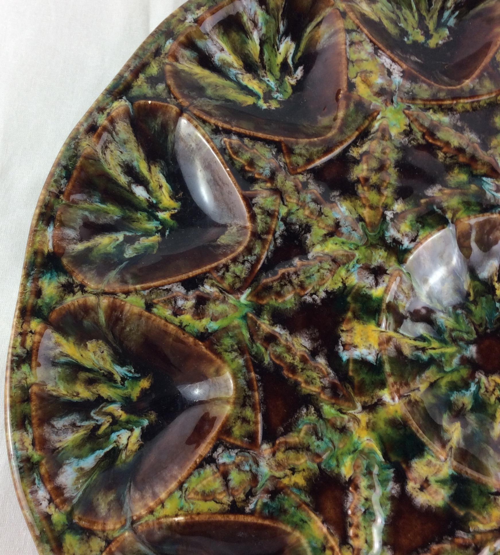 Beautiful multicolored oyster platter with detailed center. Each dip has a seashell shape. At the center, is a space for an open oyster shell or dipping sauce.

This would be a wonderful way to set the tone for a fun summer gathering. We imagine